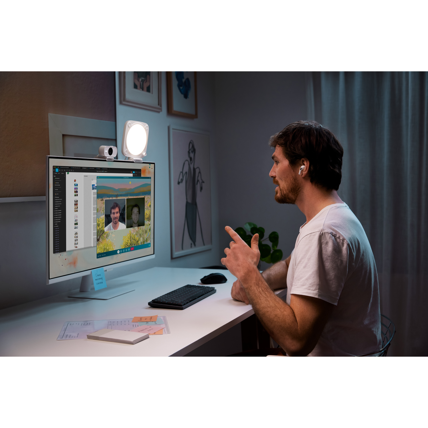 A man on a video call. A light is on the monitor.