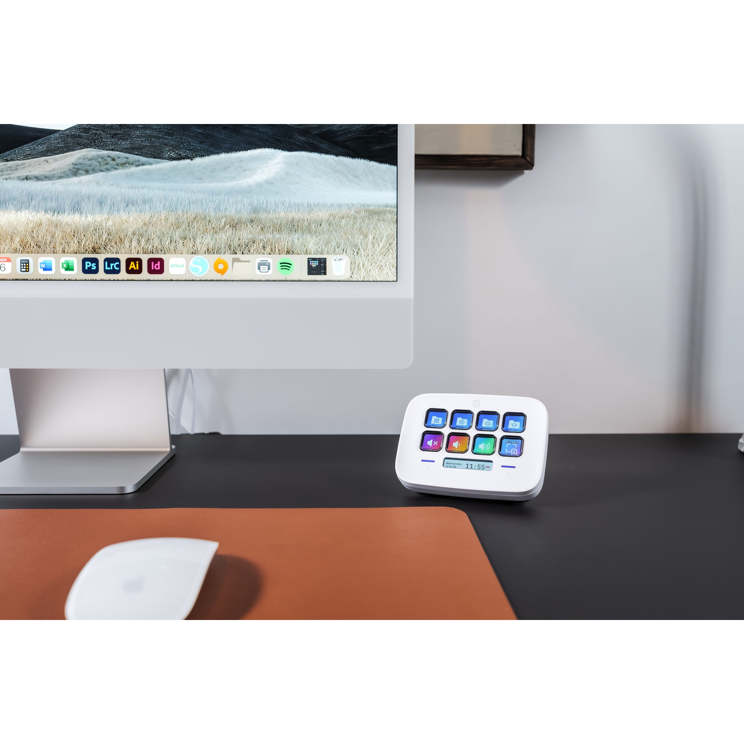 A white control panel on a desk with a computer and a mouse.