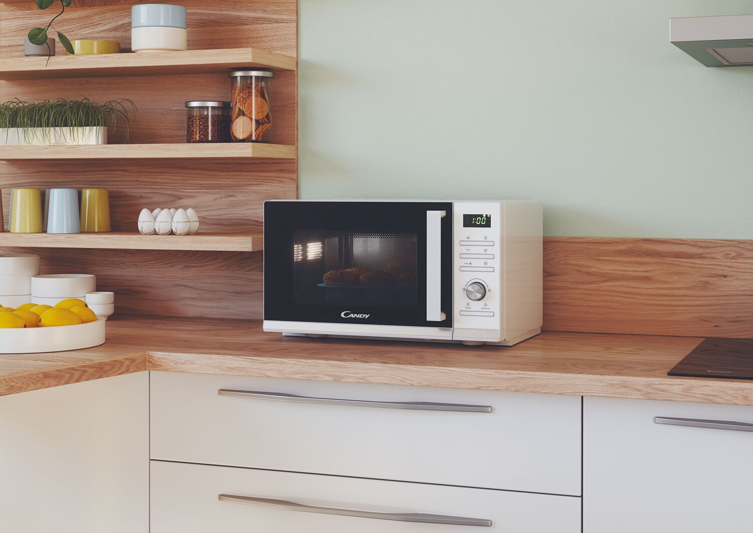 Microondas blanco en encimera de madera. Escena de cocina con estantes y accesorios.