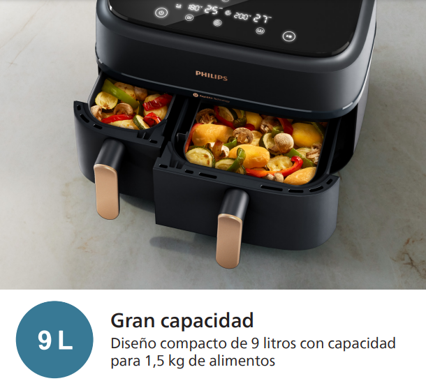 Freidora de aire de doble cámara con verduras cocidas en las cestas, diseño negro y dorado.