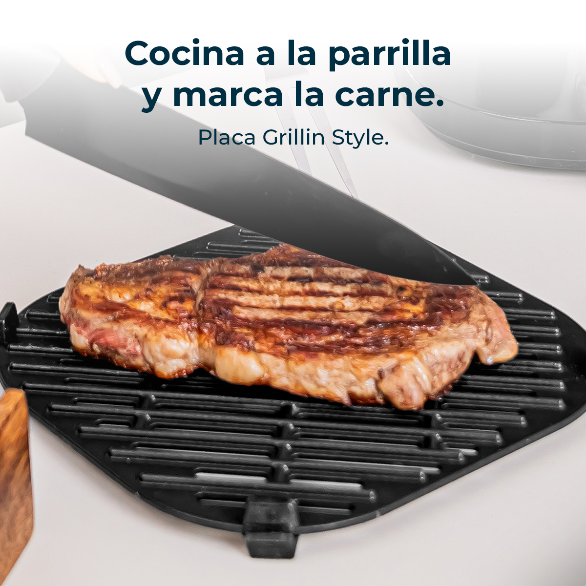 Un bistec a la parrilla en una parrilla negra, espátula negra y texto.
