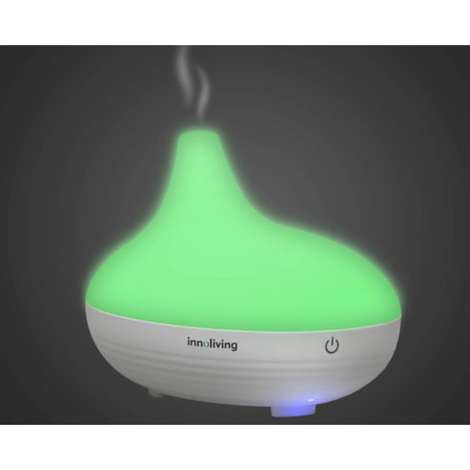 Diffusore illuminato di verde. Base bianca, parte superiore verde, vapore visibile.