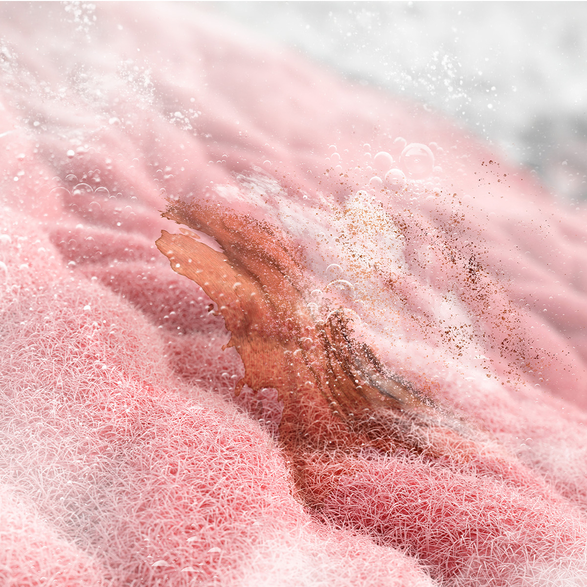 Primer plano de una esponja rosa con burbujas y materia orgánica.