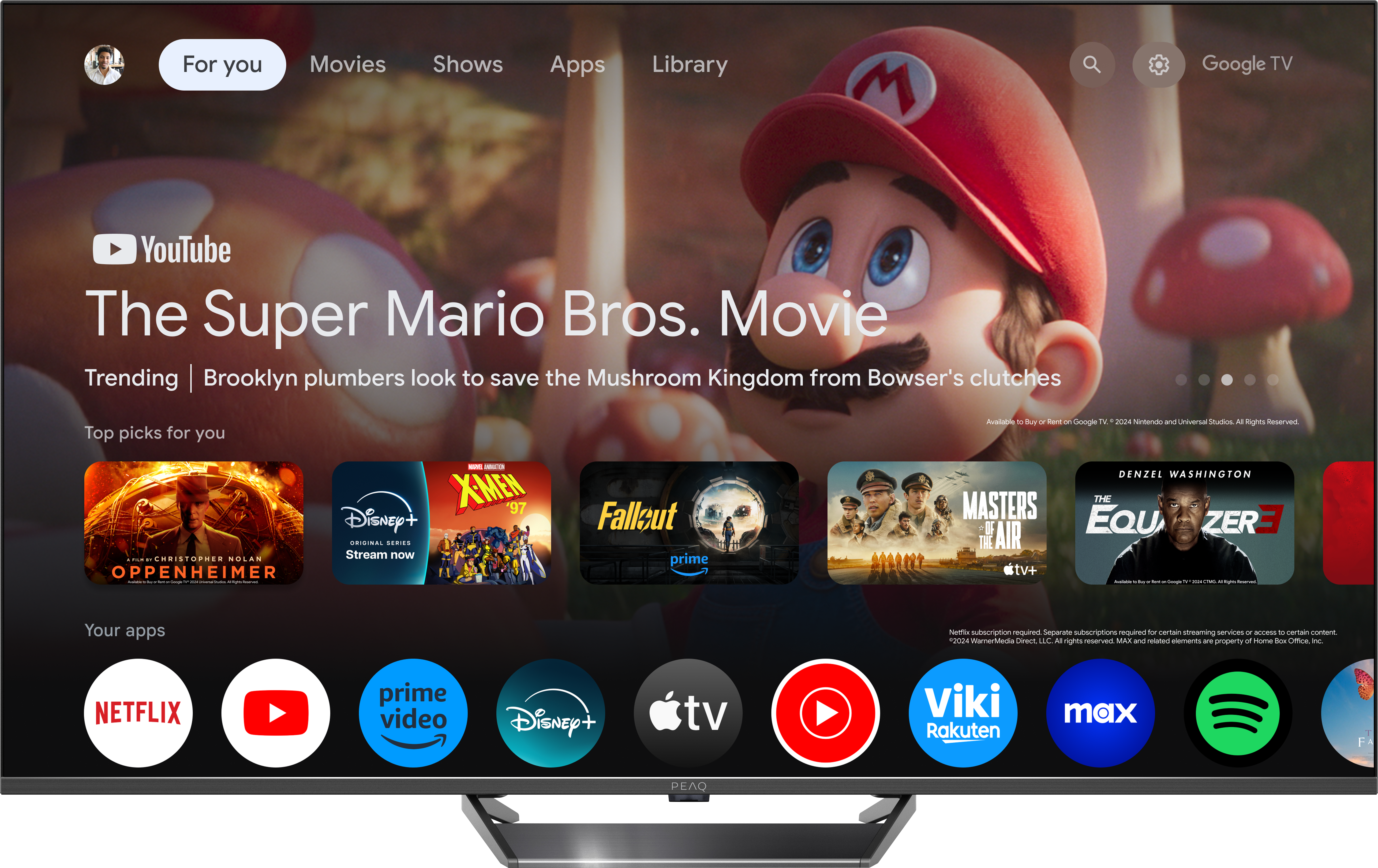 Egy nagy képernyős TV, amely a Super Mario Bros. Movie felületét mutatja alkalmazásokkal és filmválasztékkal.