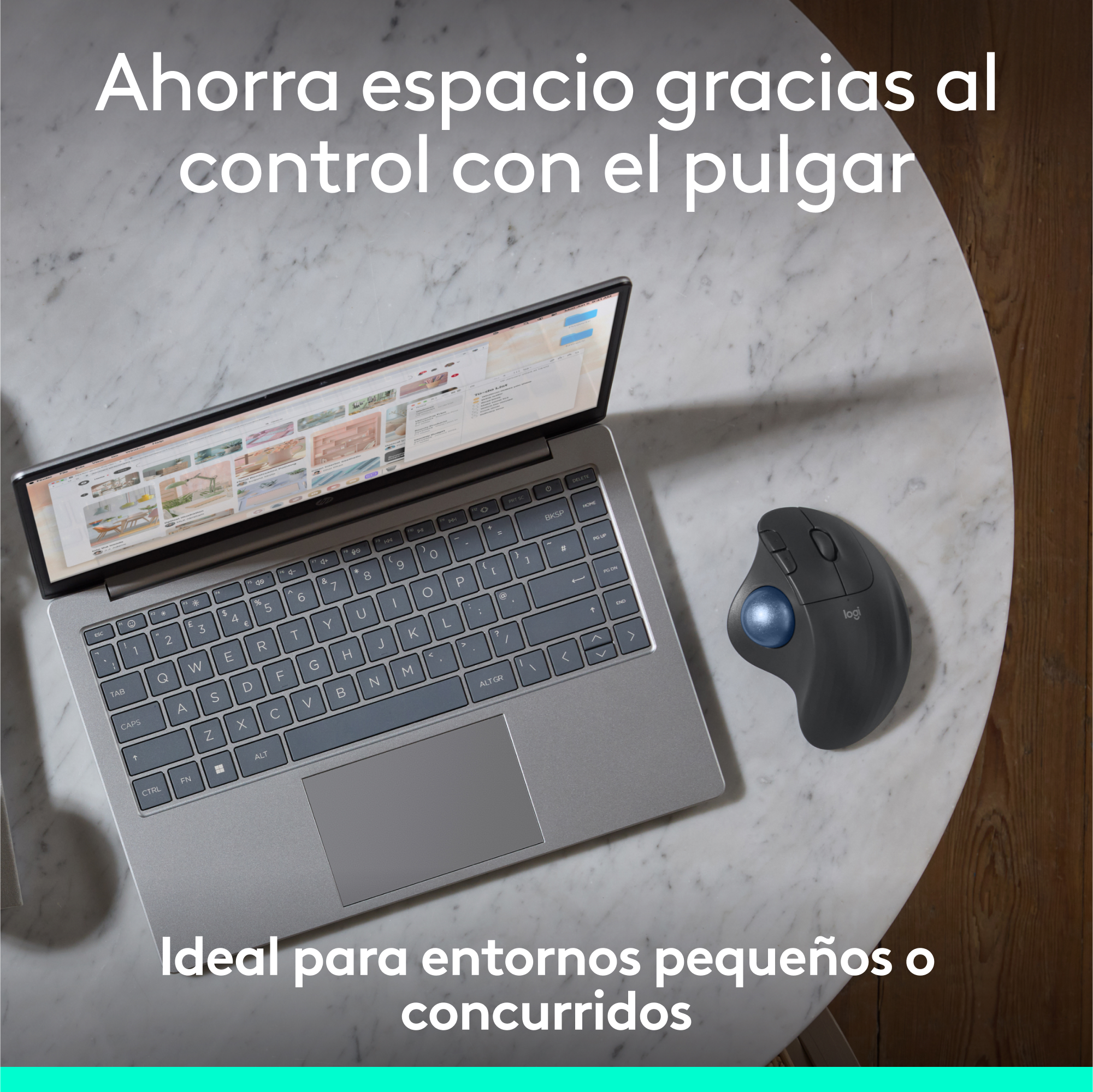 Portátil y ratón ergonómico sobre una mesa de mármol, con texto en español.