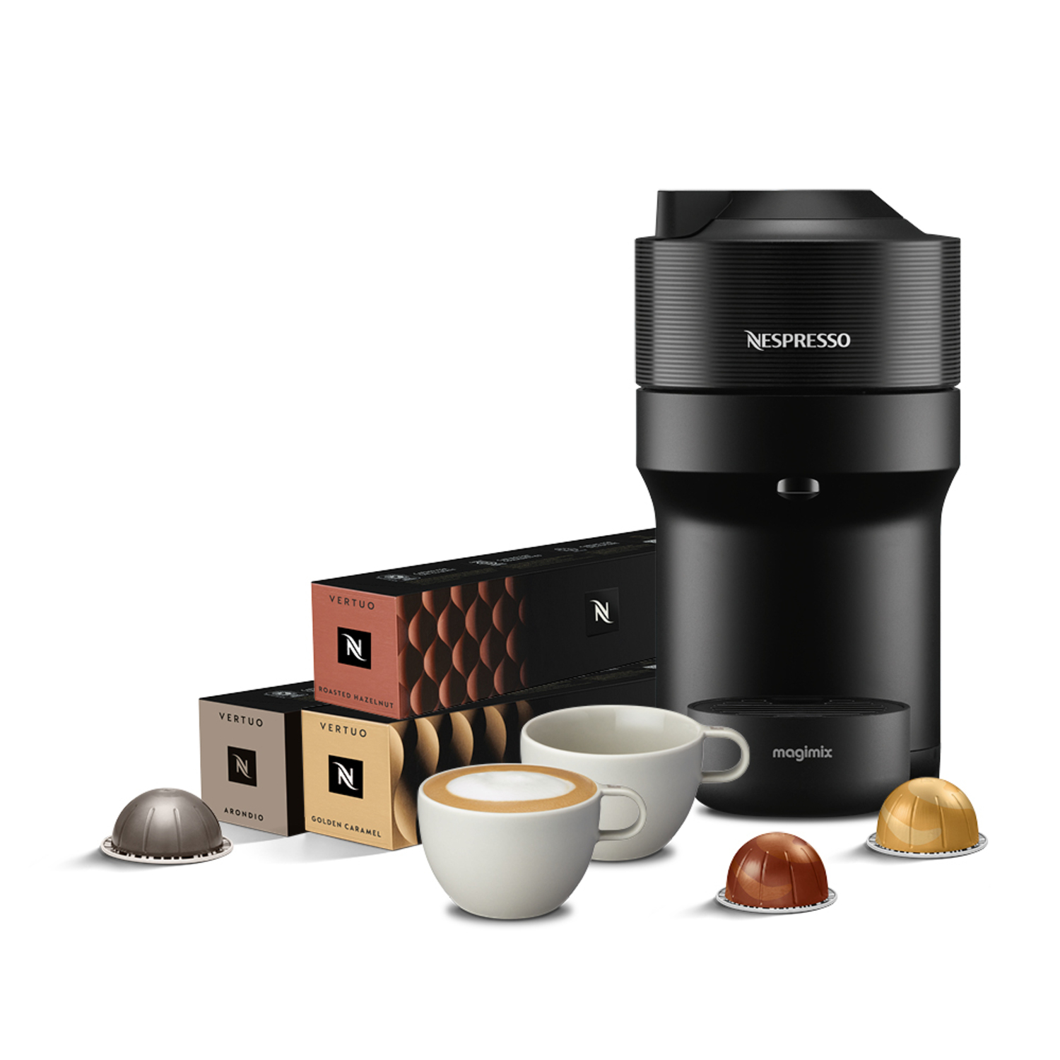 Nespresso coffee machine with pods, cups, and coffee capsules in front of it on a white surface.