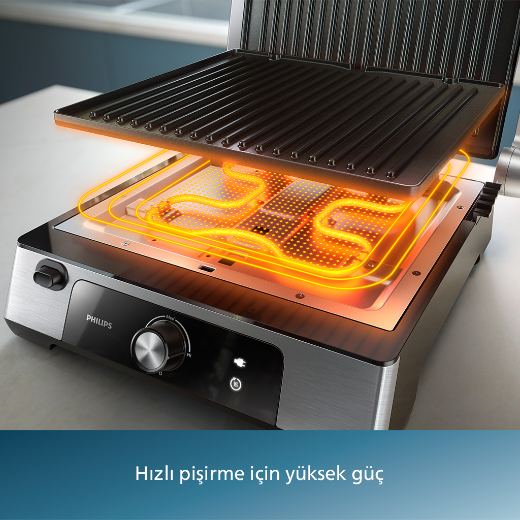 Philips ızgara, açık üst kısım, sıcak ısıtma elemanları turuncu parlıyor, açık bir yüzey üzerinde.