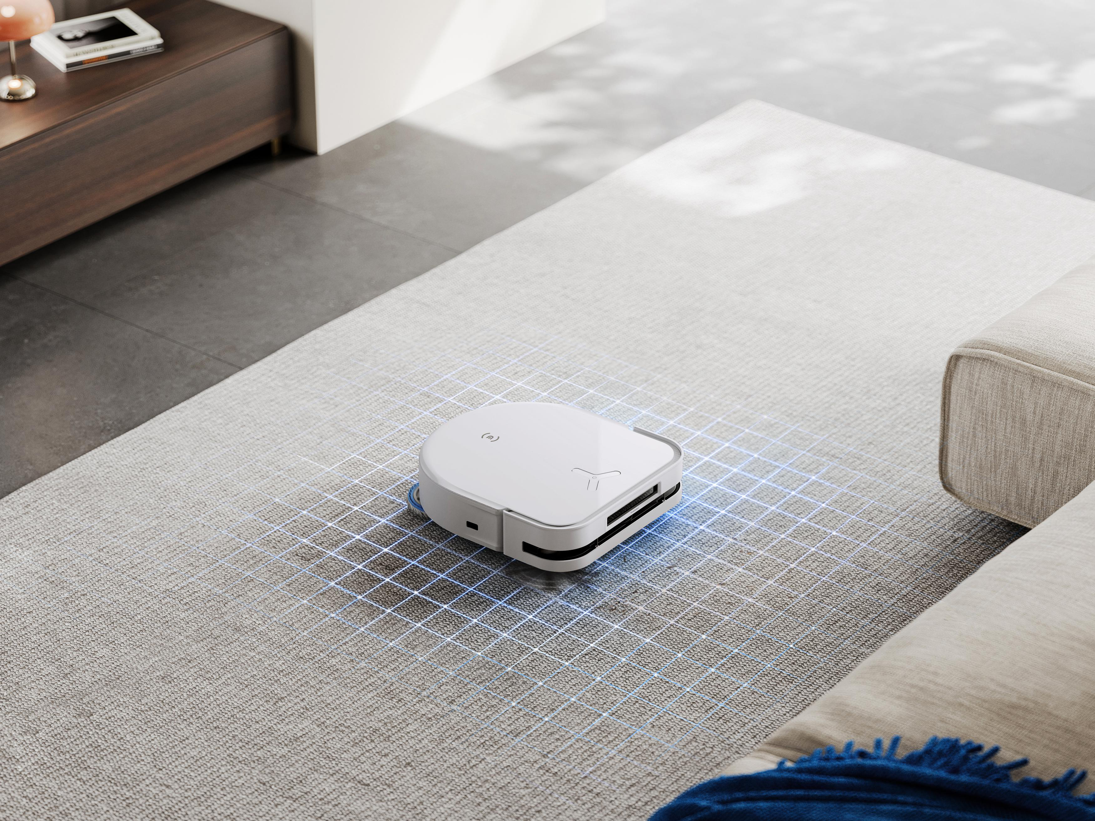 Ein weißer Roboter-Staubsauger auf einem Teppichboden mit blauem Gittermuster.