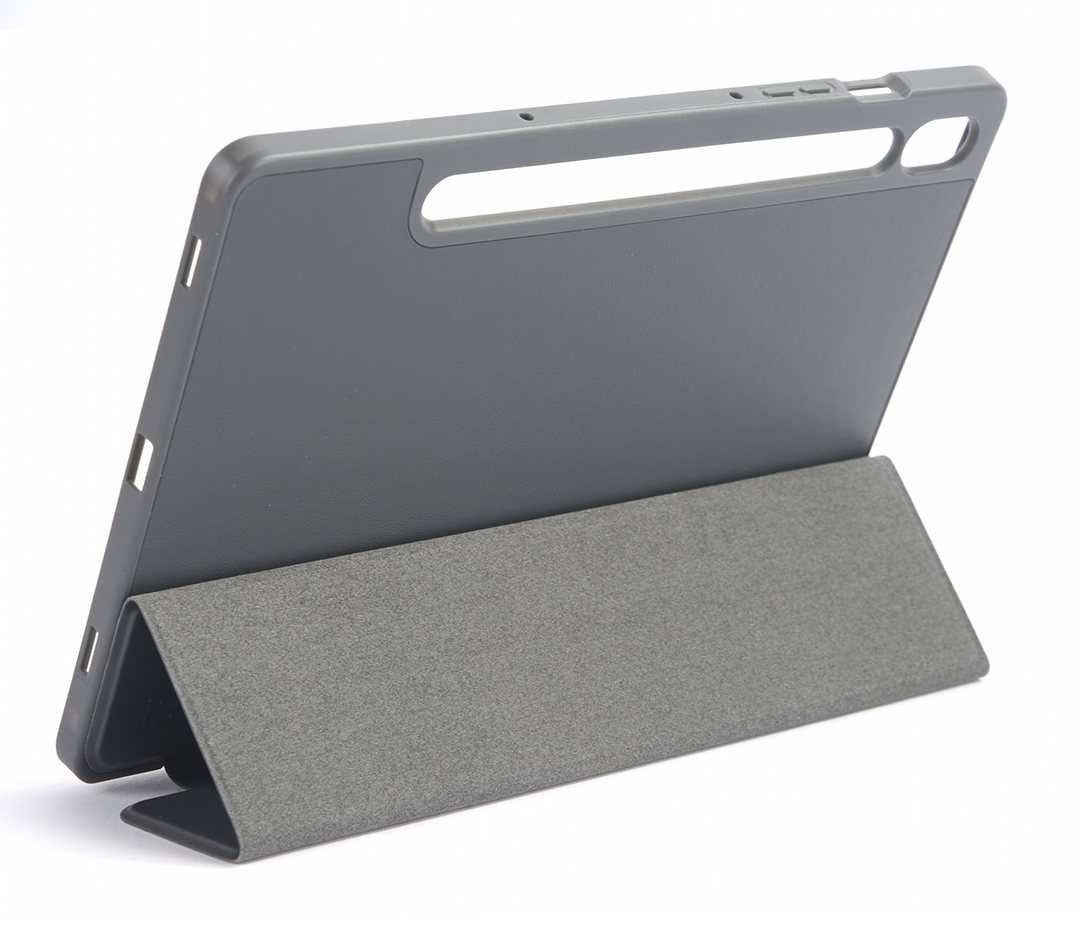 Szürke tablet tokban, felállítva, fehér felületen.