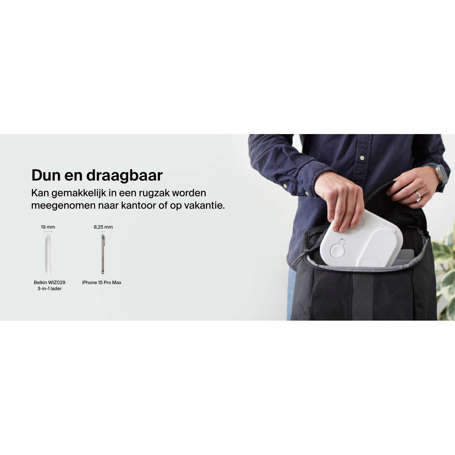 Person packing a white Belkin charger into a black bag. Other items are also visible.