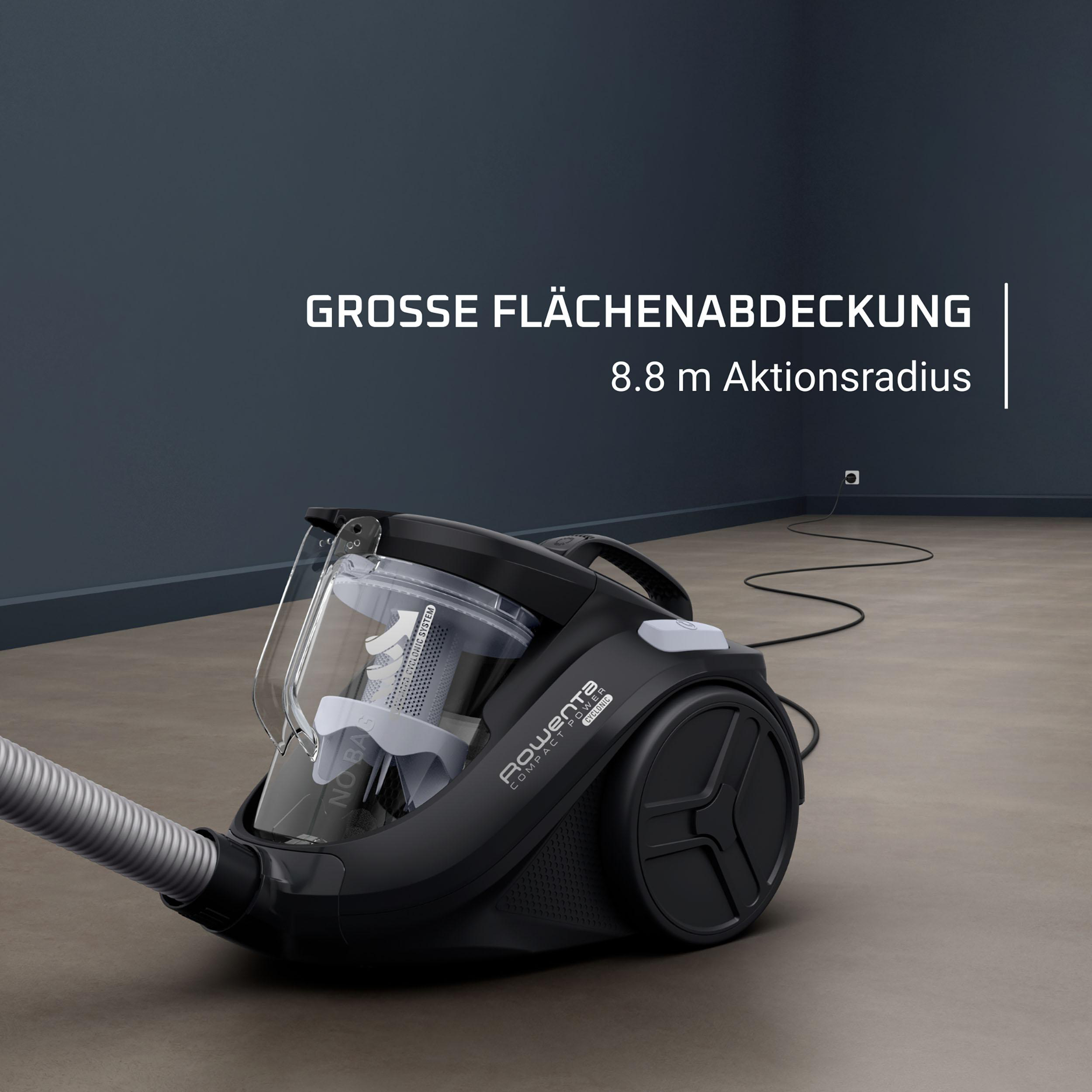 Ein schwarzer Staubsauger mit Schlauch auf Holzboden mit Textüberlagerung.