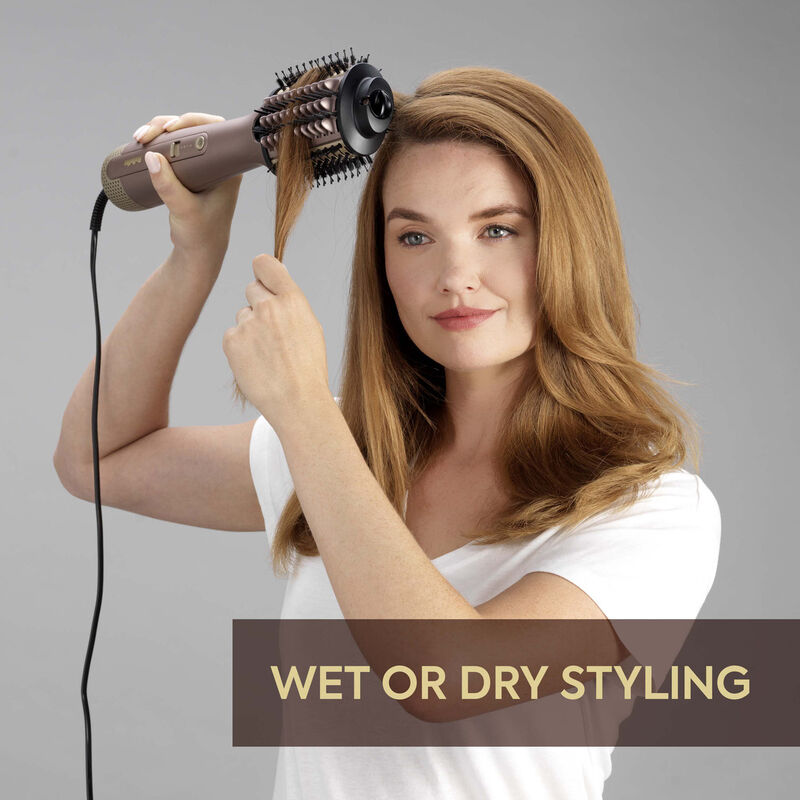 Donna che si acconcia i capelli con una spazzola rotante, testo: Wet or Dry Styling.