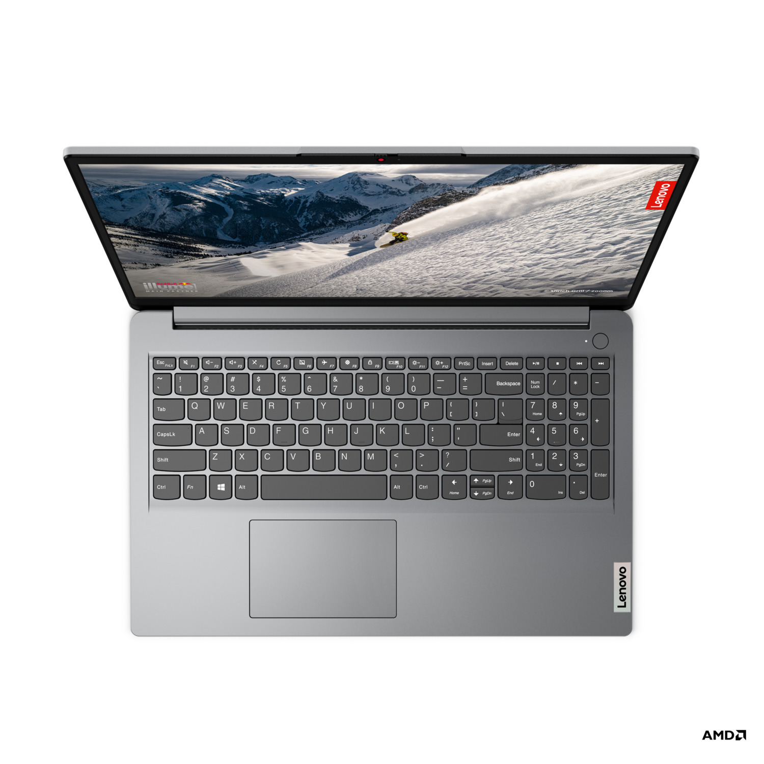 Un ordinateur portable Lenovo argenté affichant un skieur à l'écran.