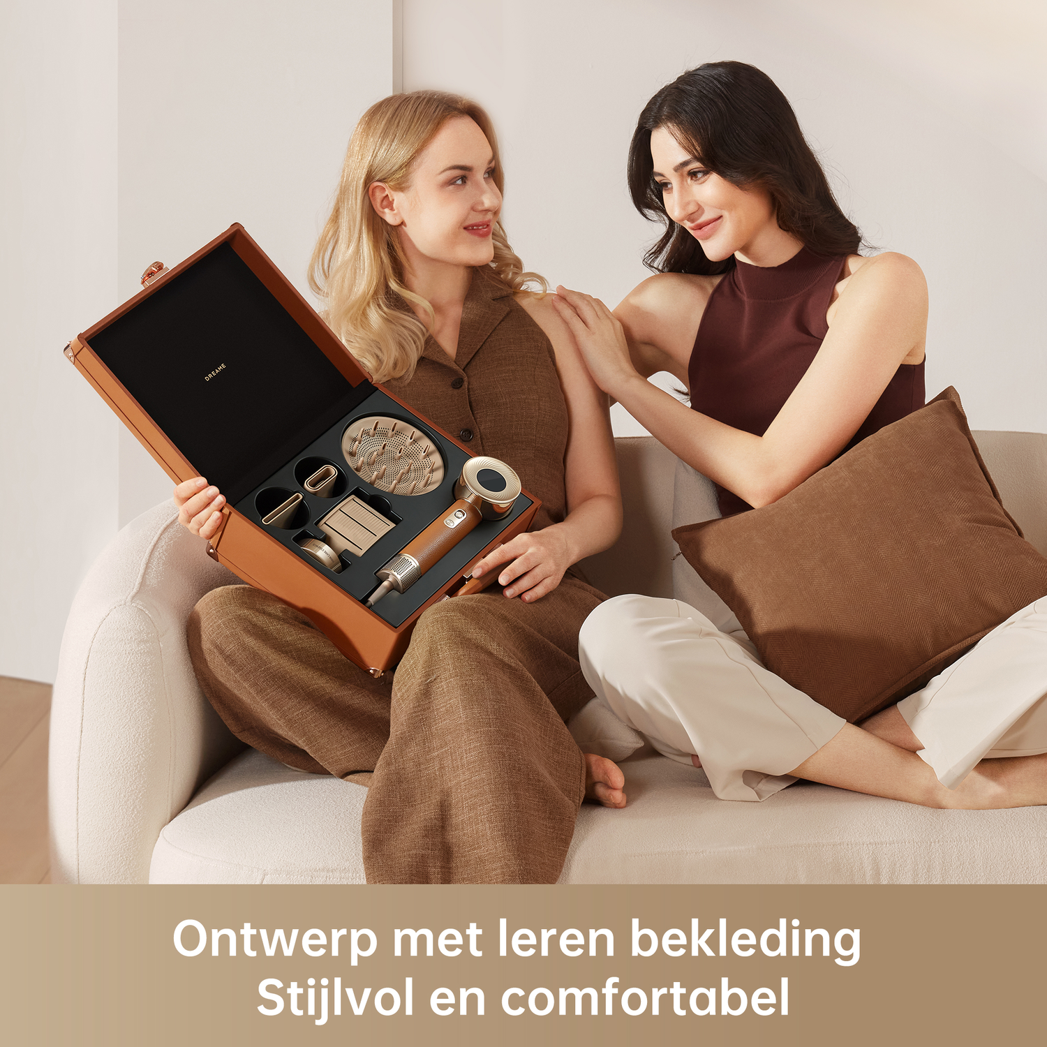 Two women with beauty tools in a case, sitting on a sofa.