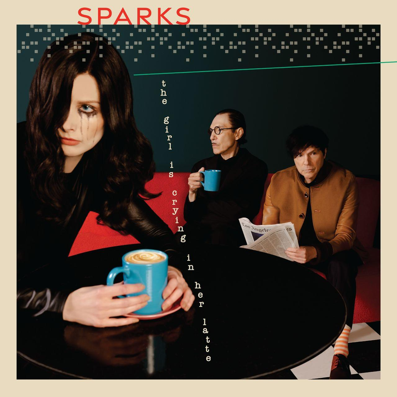 Album borító. Egy fekete szemfestésű nő ül egy asztalnál. Két férfi ül mögötte. A cím: 'Sparks'.