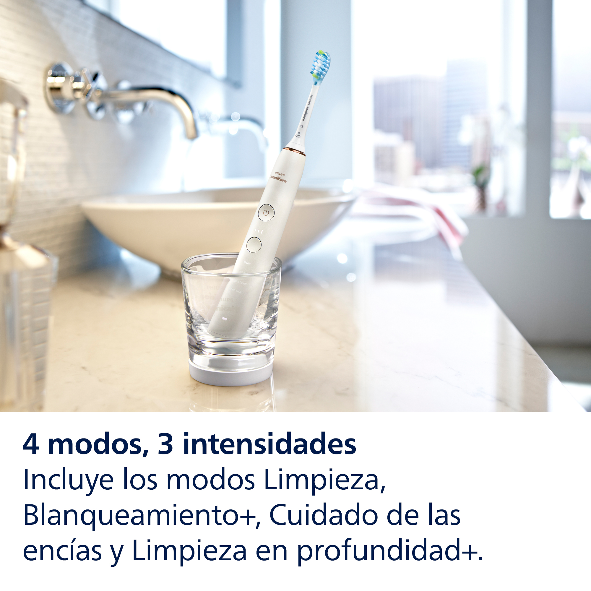 Cepillo de dientes eléctrico blanco en un vaso, texto abajo en español.