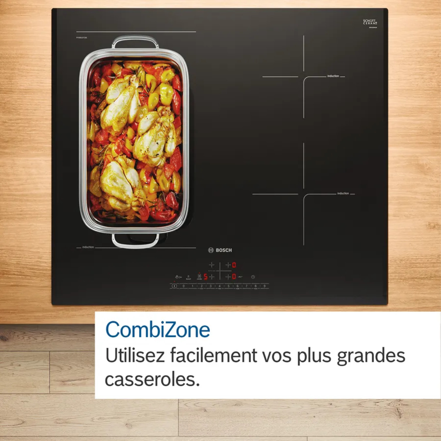 Vue de dessus d'une table de cuisson à induction noire avec un plateau de nourriture.