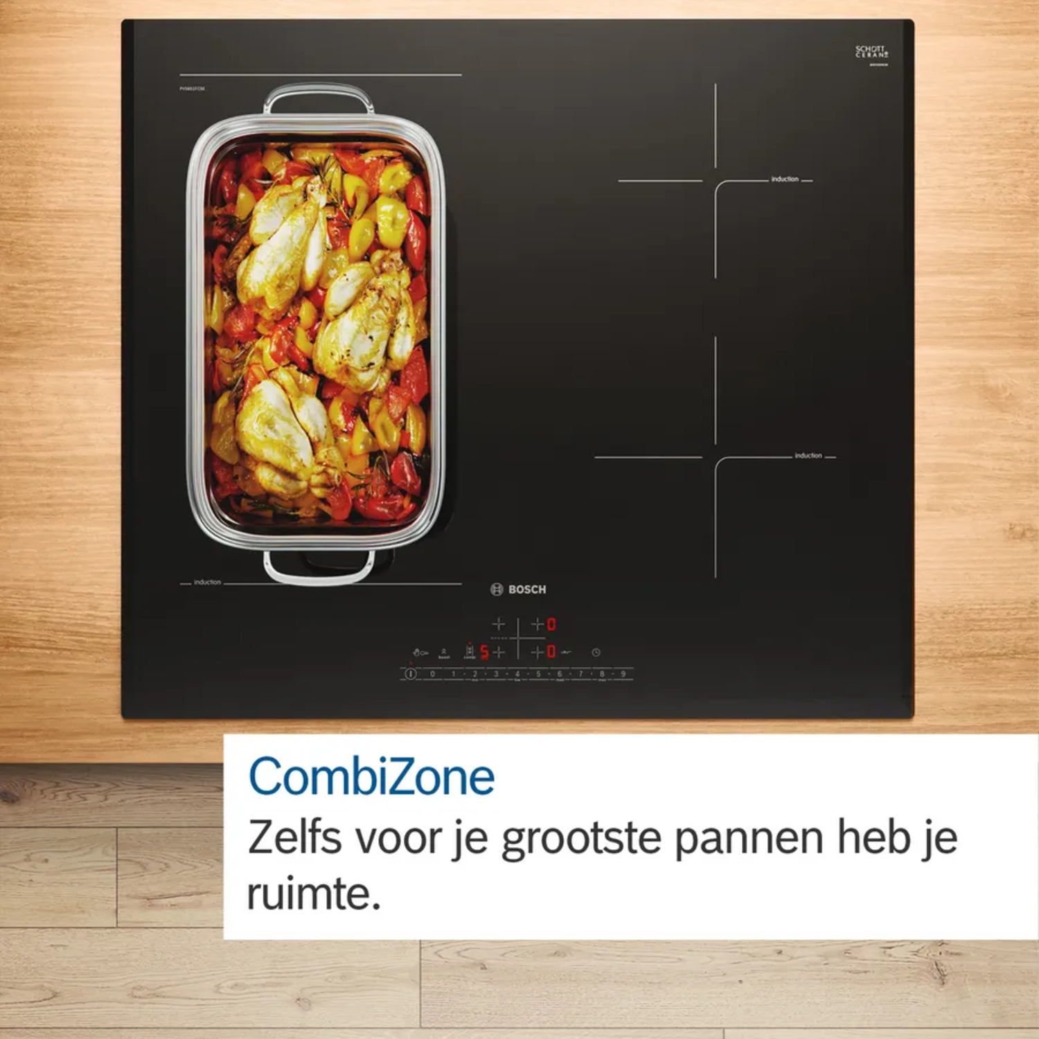 Een zwarte inductiekookplaat met een bakje met gekookt voedsel.
