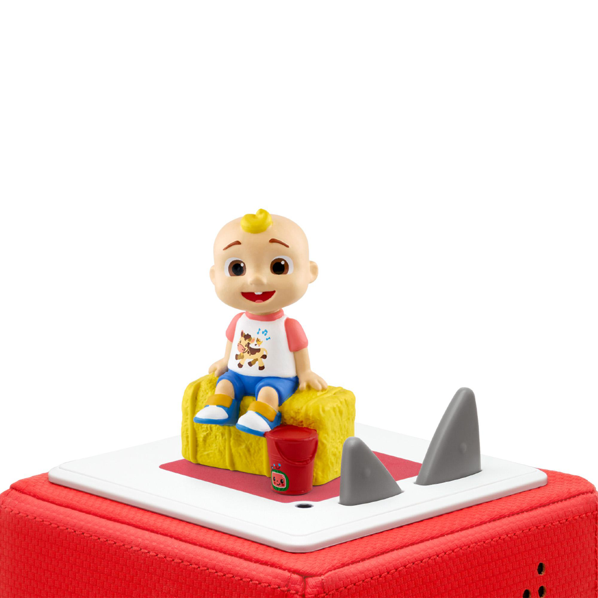 Cartoonfigur sitzt auf Heu, mit einem roten Eimer und Haifischflossen.