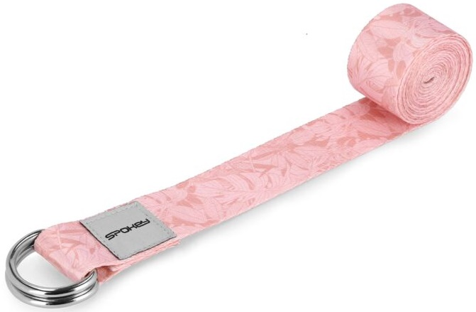 Różowy pasek do jogi z kwiatowym wzorem, zwinięty, ze srebrnymi metalowymi pierścieniami.