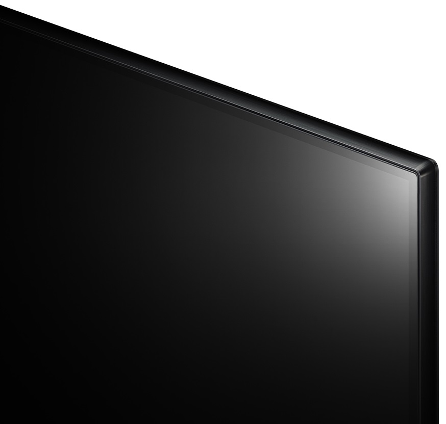 Zbliżenie krawędzi ekranu telewizora z czarną ramką i białym tłem.