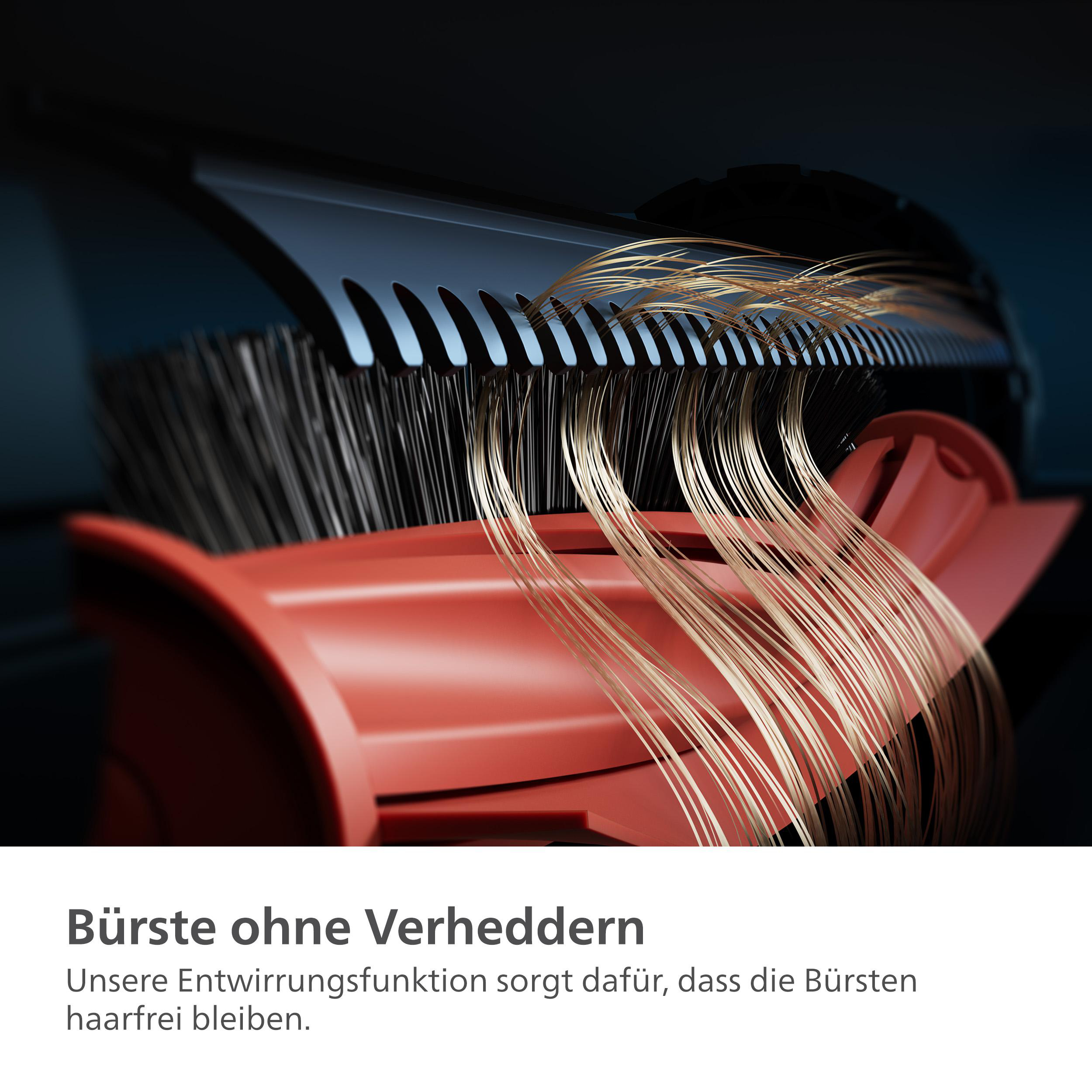 Ein Haarschneider mit Kammaufsatz. Goldene Haarsträhnen werden gezeigt, die geschnitten werden.