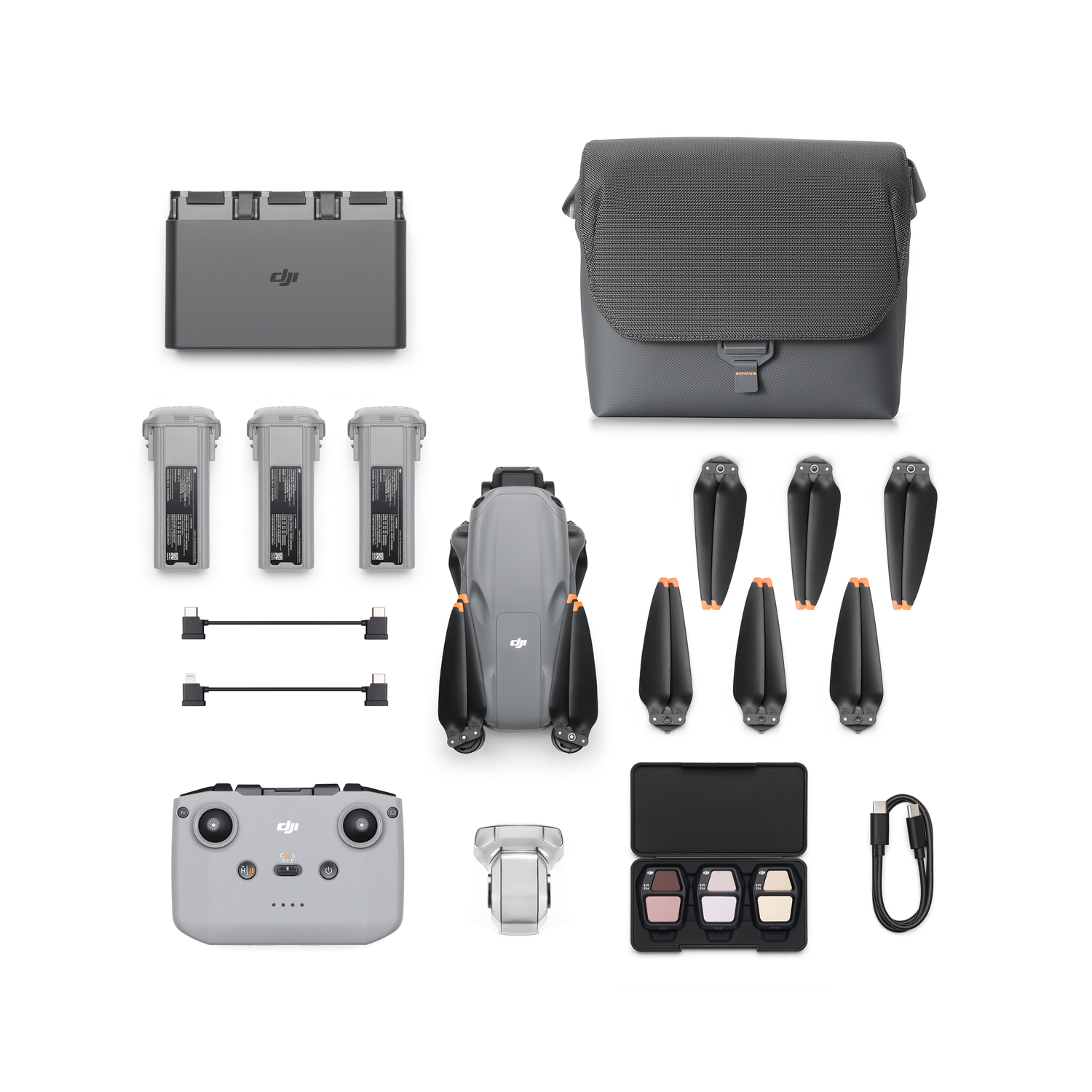 Drone kit with drone, batteries, charger, and accessories, all gray.