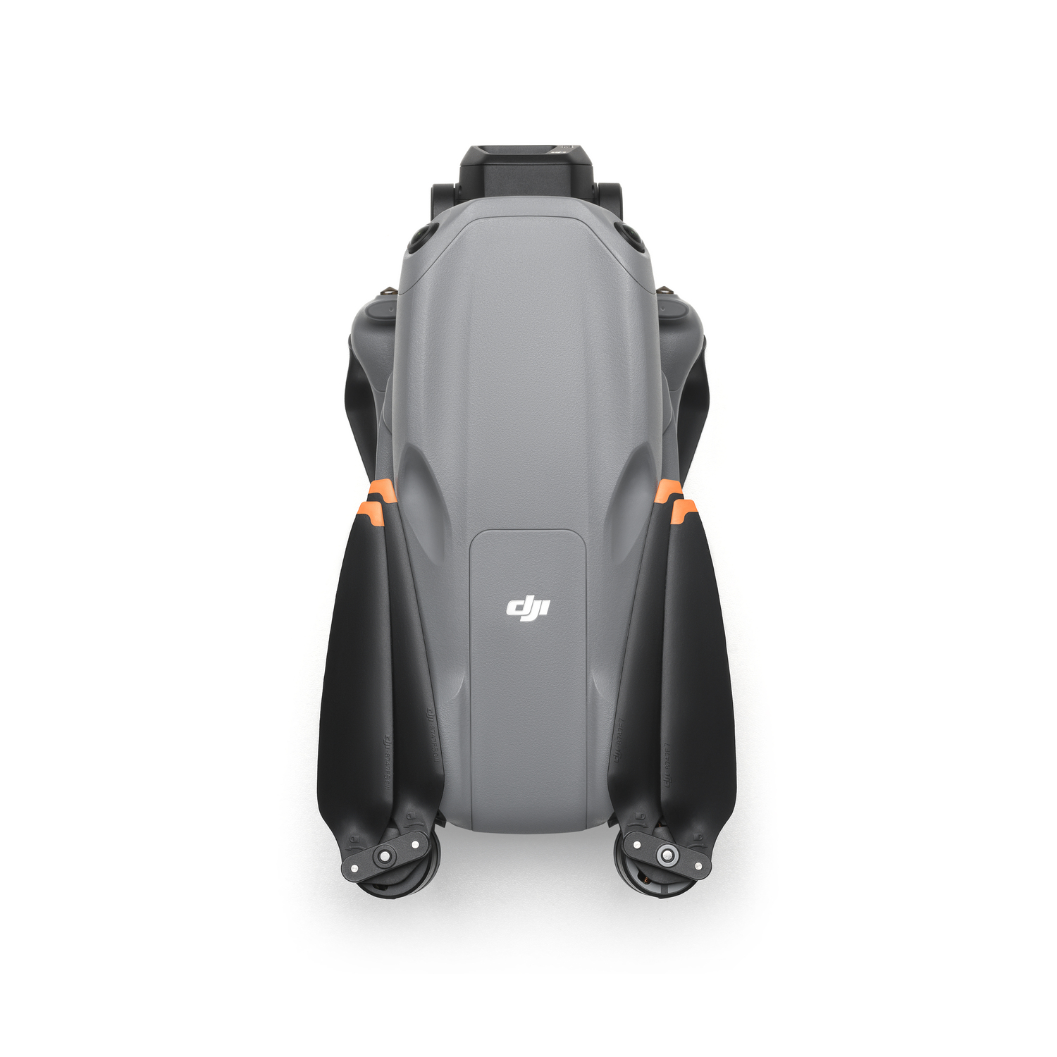 Drone, top view, grey body with orange accents and black propellers.