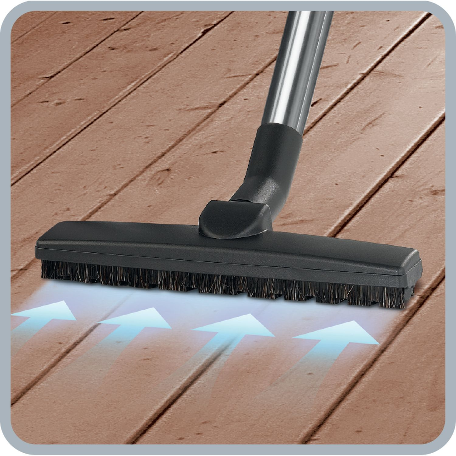 A vacuum cleaner head on wooden planks. Arrows indicate air flow.