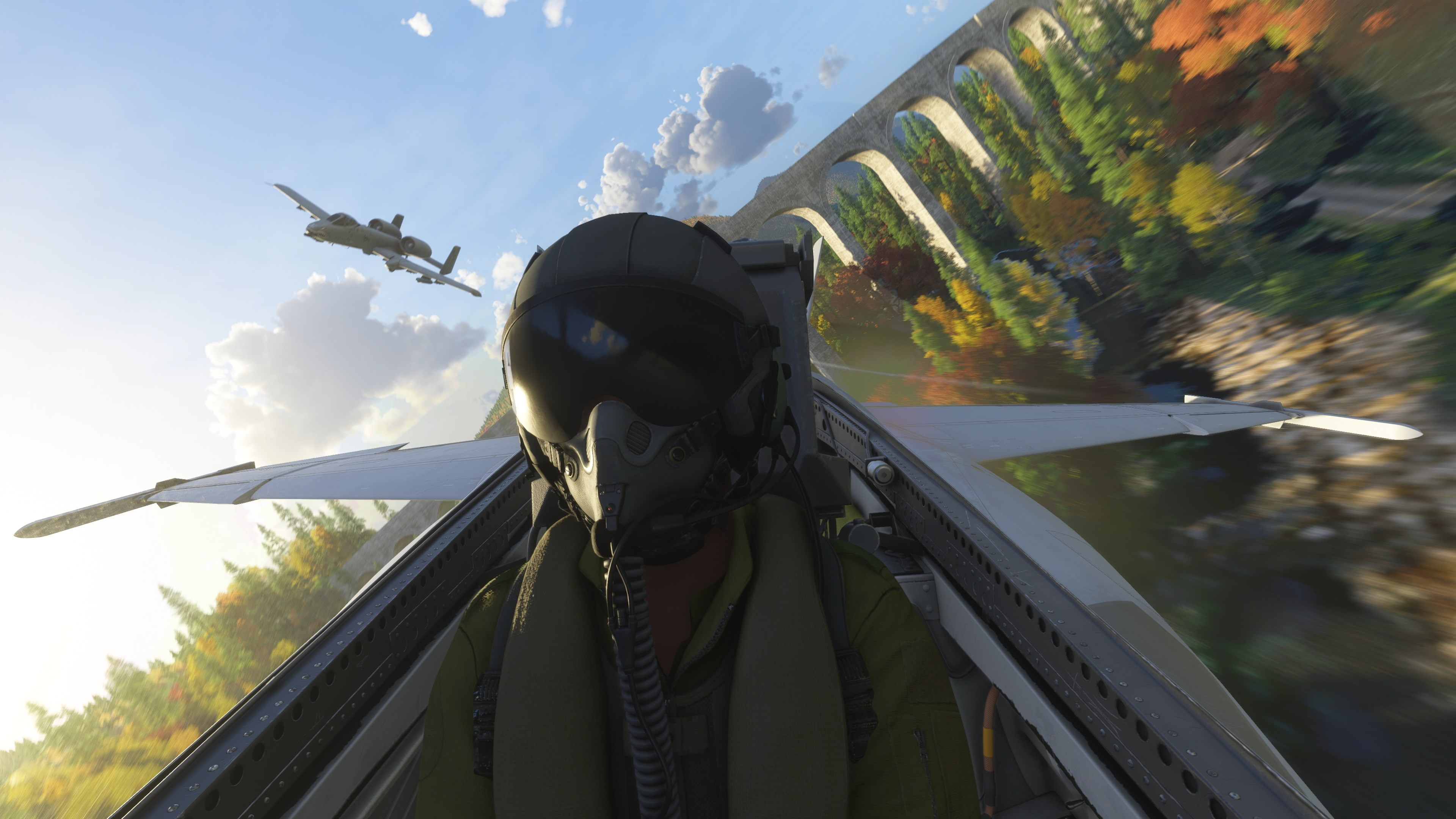 Pilotansicht aus dem Cockpit eines Jets. Ein anderes Flugzeug fliegt. Berge und Brücke im Hintergrund.