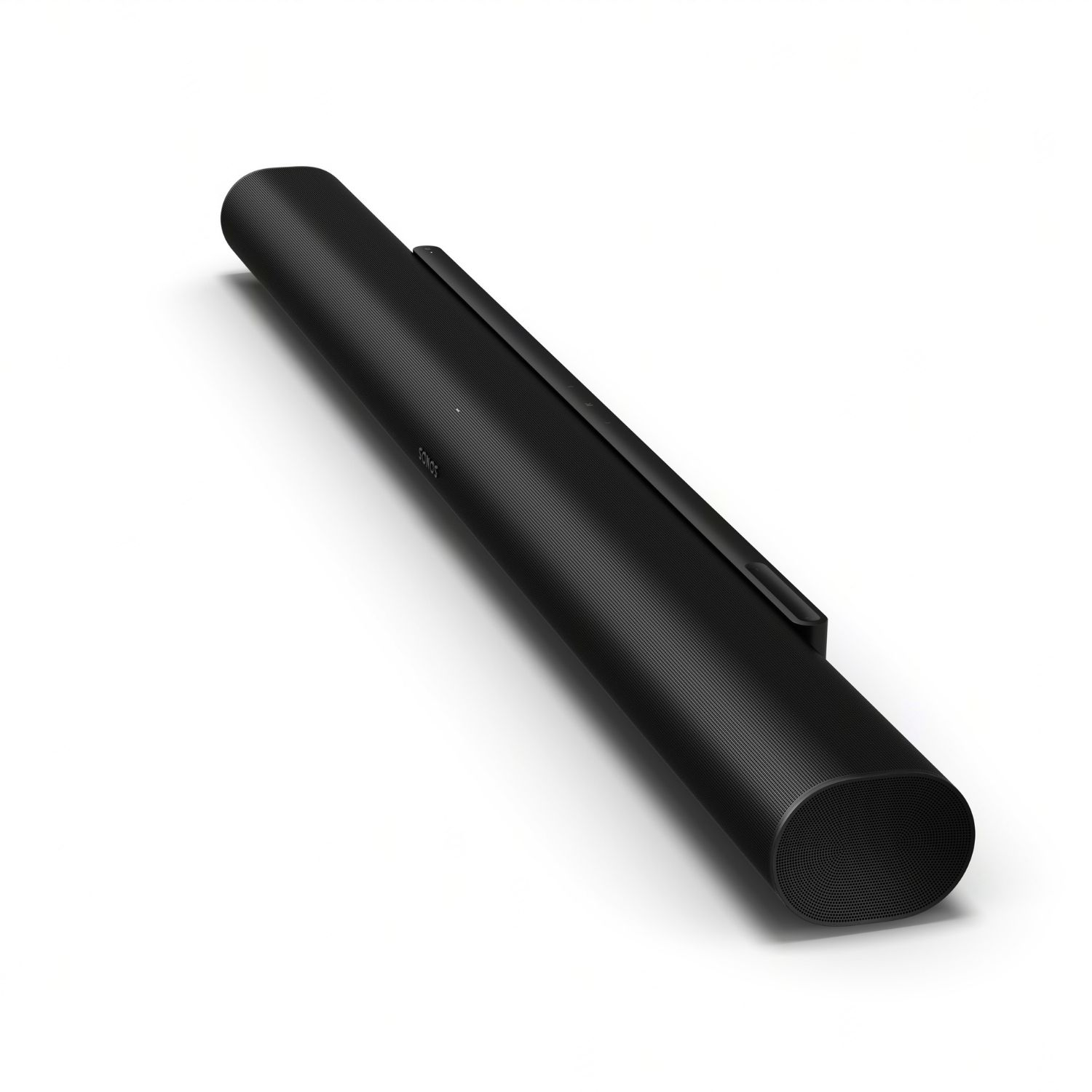 Barra de sonido negra con forma cilíndrica, inclinada sobre una superficie blanca.