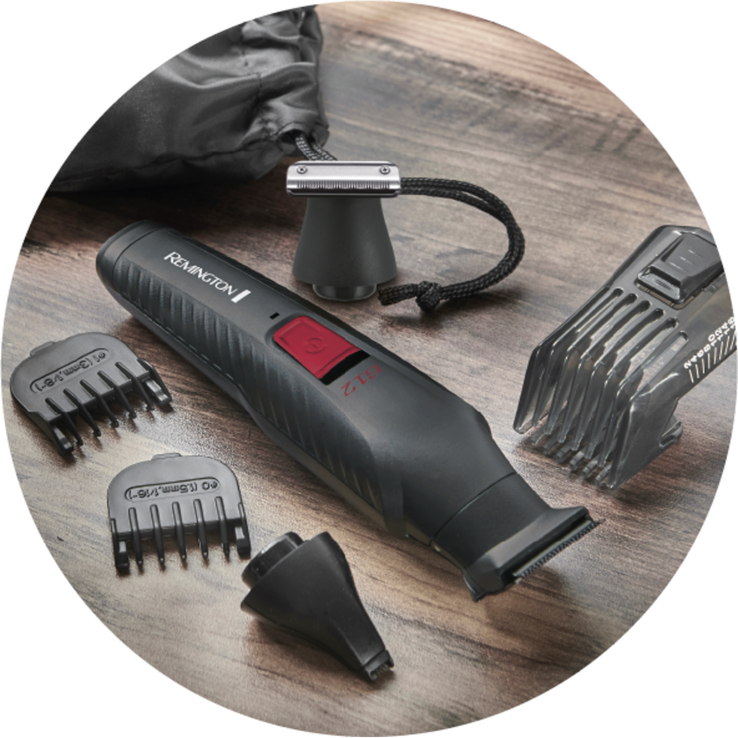 Black Remington trimmer and accessories on a wooden surface, including guards and a bag.