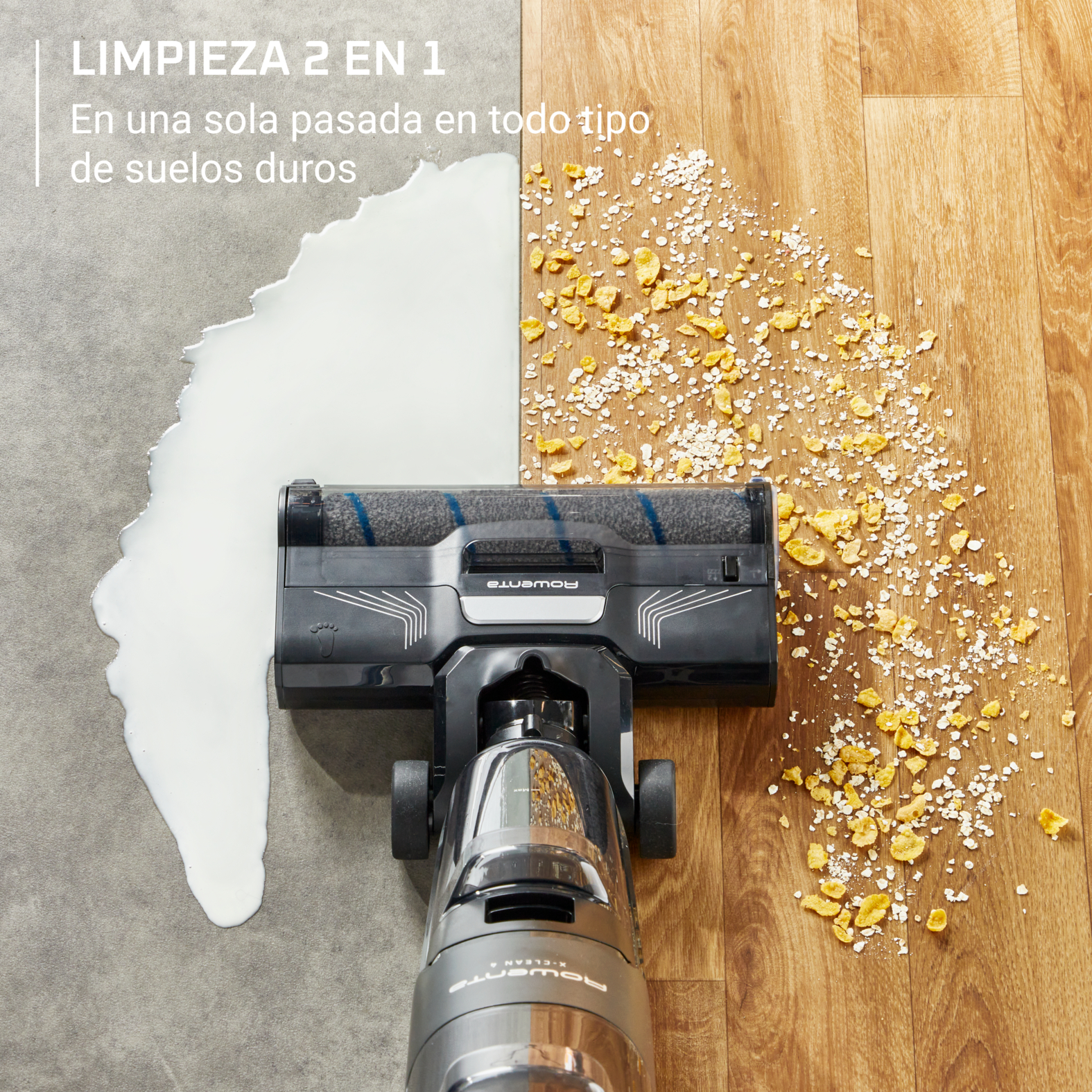 Aspiradora limpiando una superficie con leche derramada y partículas de comida.