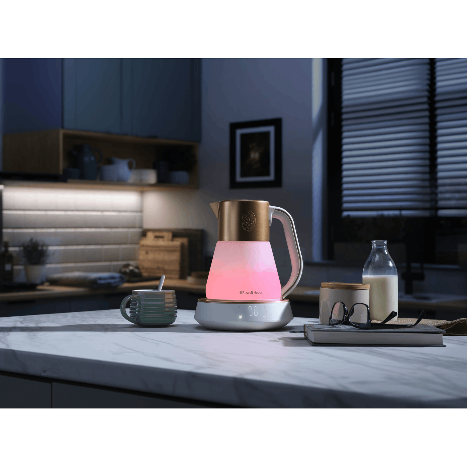 Electric kettle on a counter with a mug and milk bottle. The kettle has a pink glow.