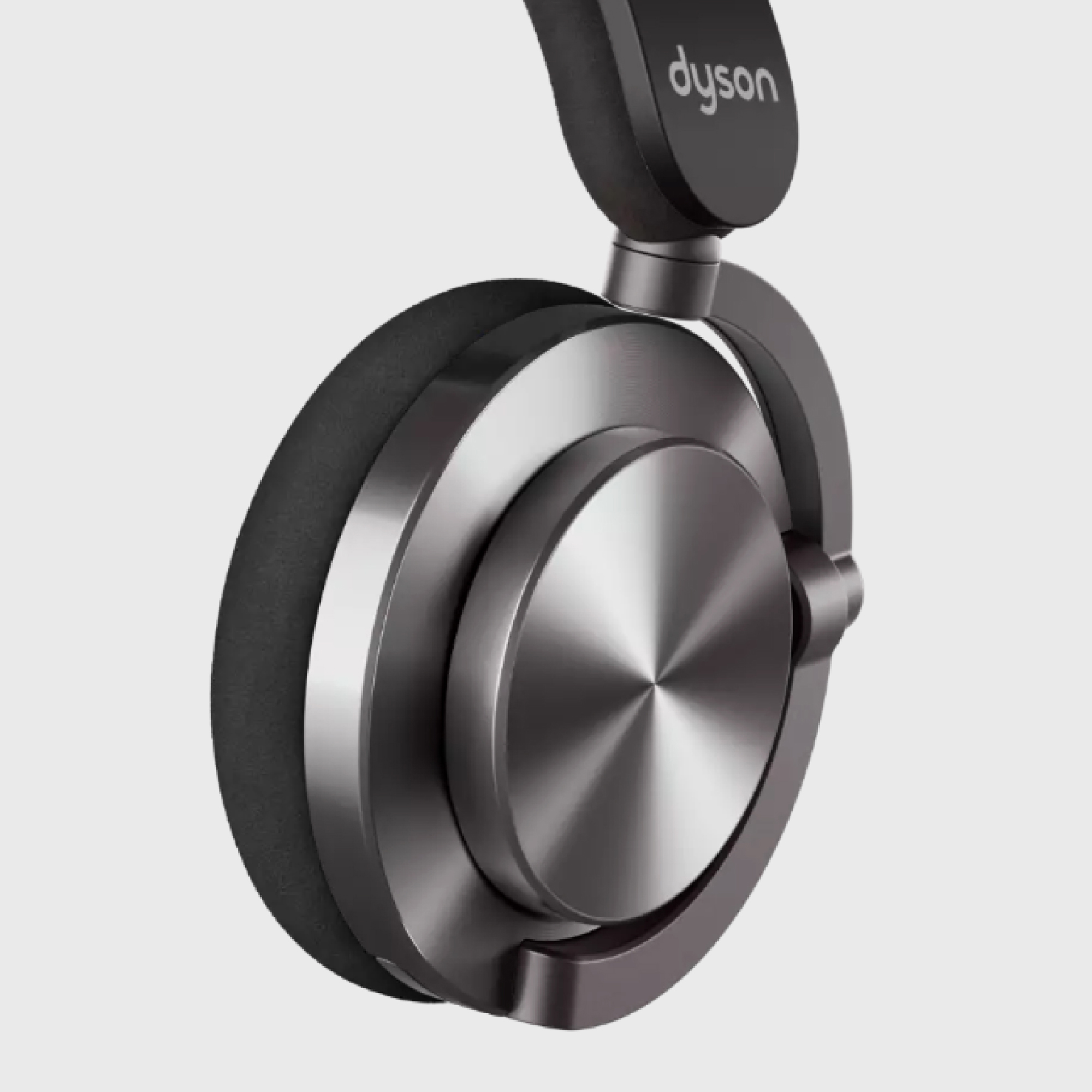 Czarne słuchawki Dyson. Metalowe nauszniki z logo Dyson. Opaska na górze.