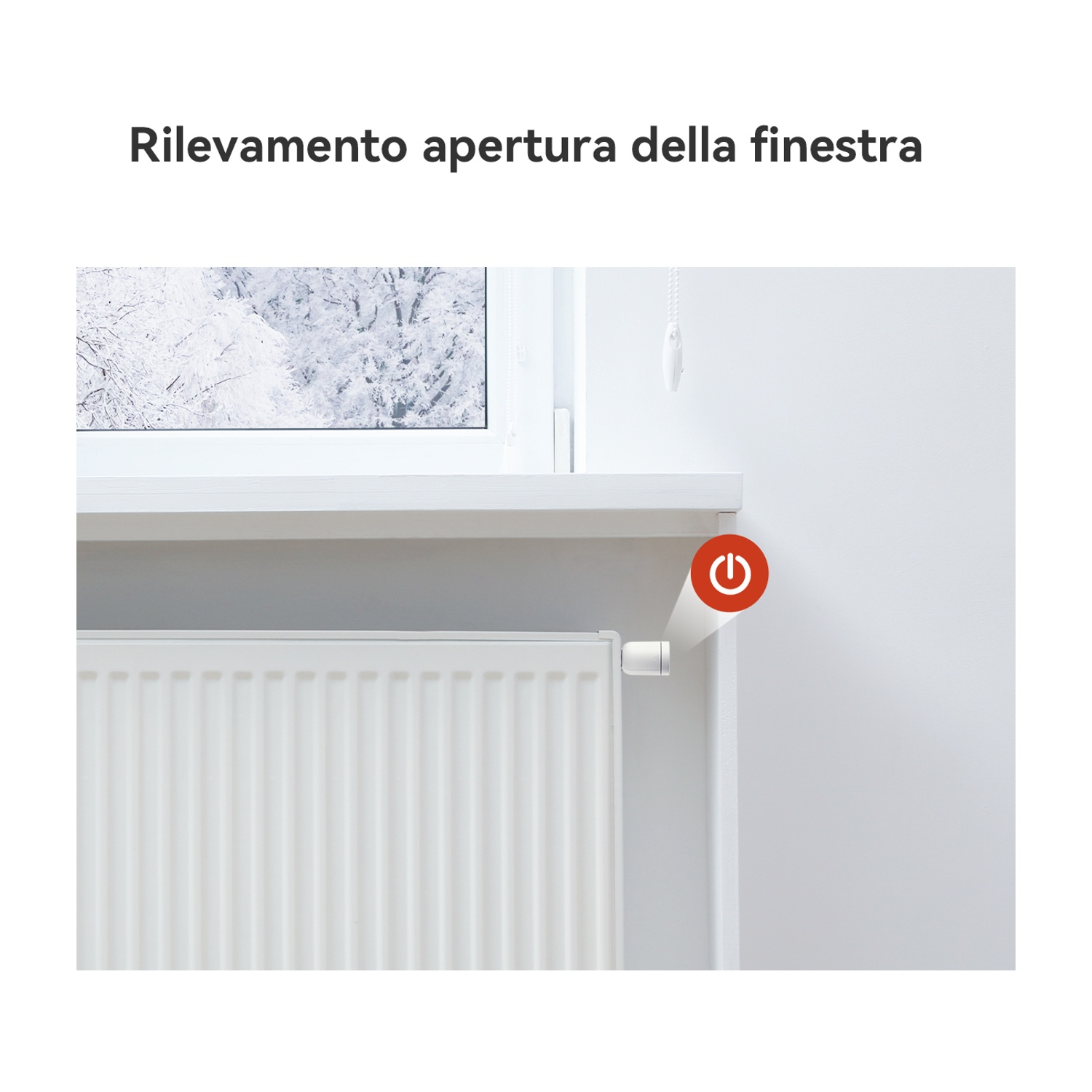 Radiatore bianco sotto una finestra. Pulsante di accensione rosso acceso.