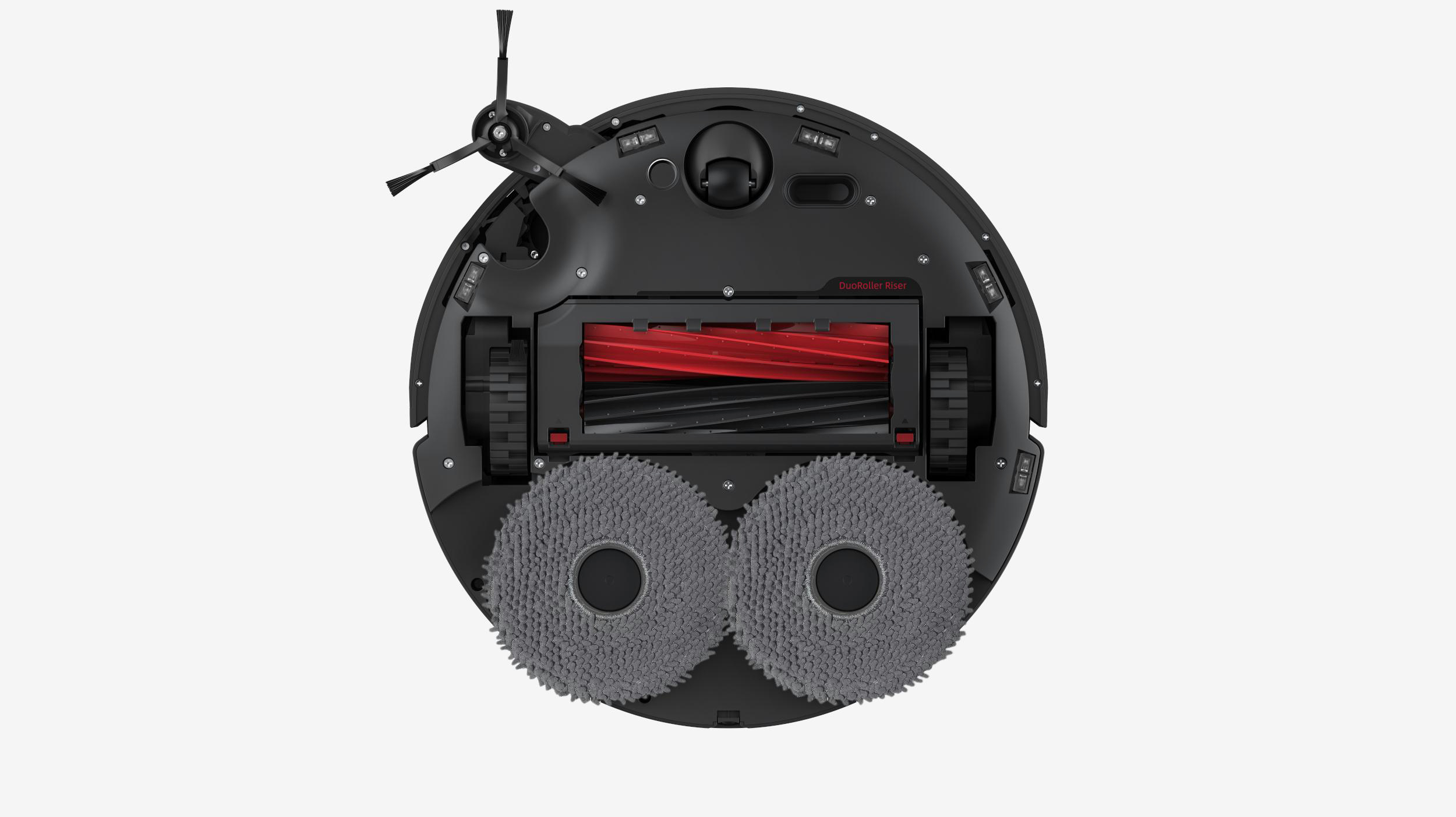 Die Unterseite eines schwarzen Roboter-Staubsaugers mit zwei Bürsten und einer roten Mittelbürste.