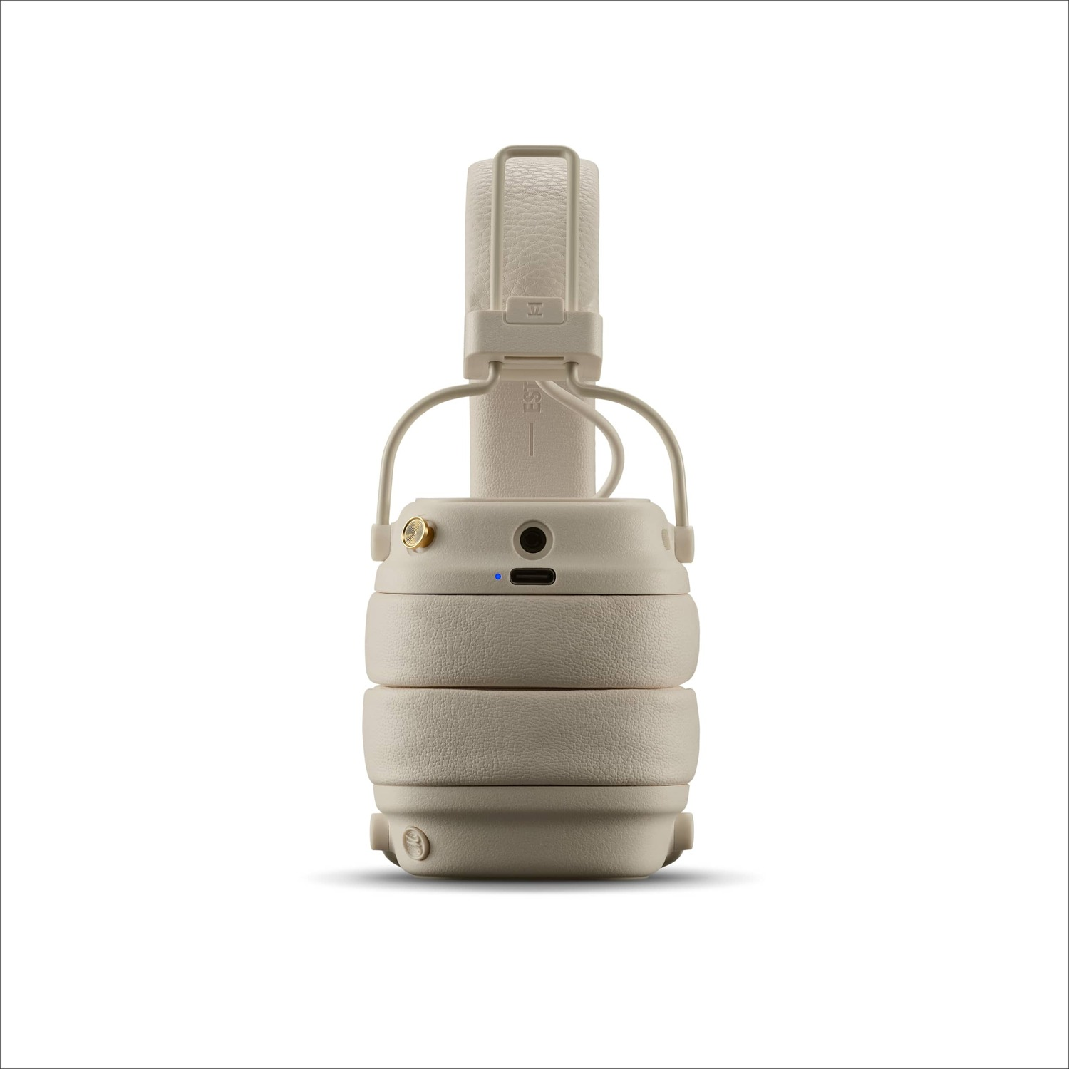 Beige Marshall headphones, folded, on a white background. The headphones have a button and a charging port.