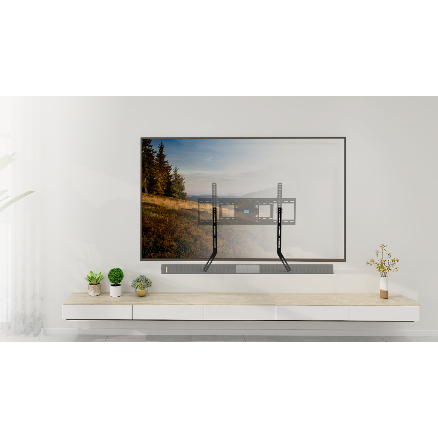 Een zwarte tv-beugel geïnstalleerd op een witte muur. Er is een tv op gemonteerd, met daaronder een soundbar.