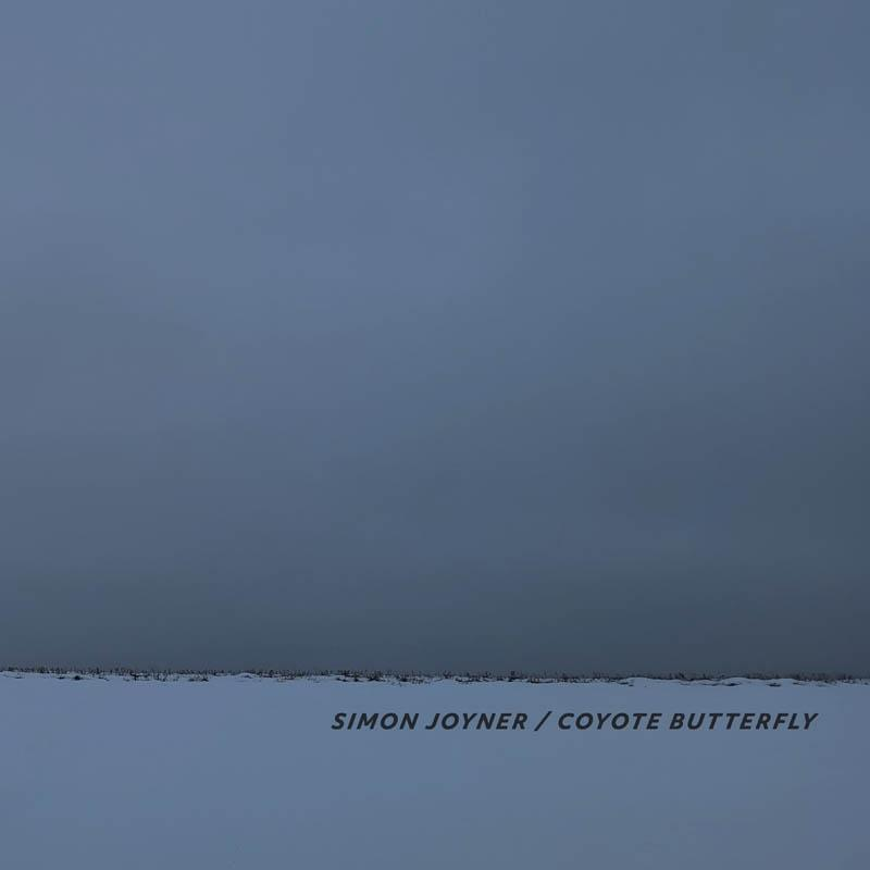 Eine verschneite Landschaft unter einem dunkelblauen Himmel. Text: Simon Joyner / Coyote Butterfly.