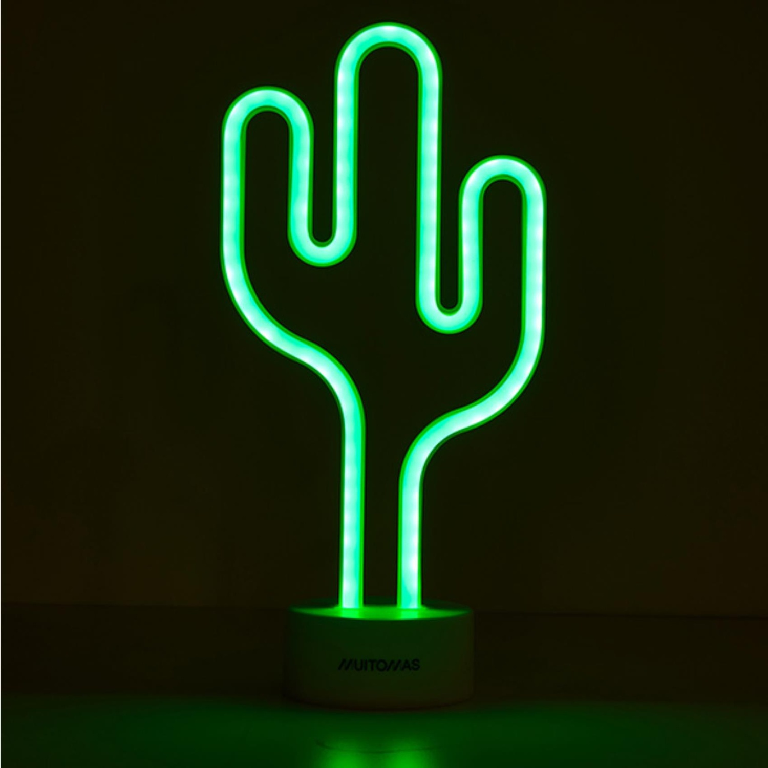 Luce cactus al neon verde su base bianca, su sfondo scuro.