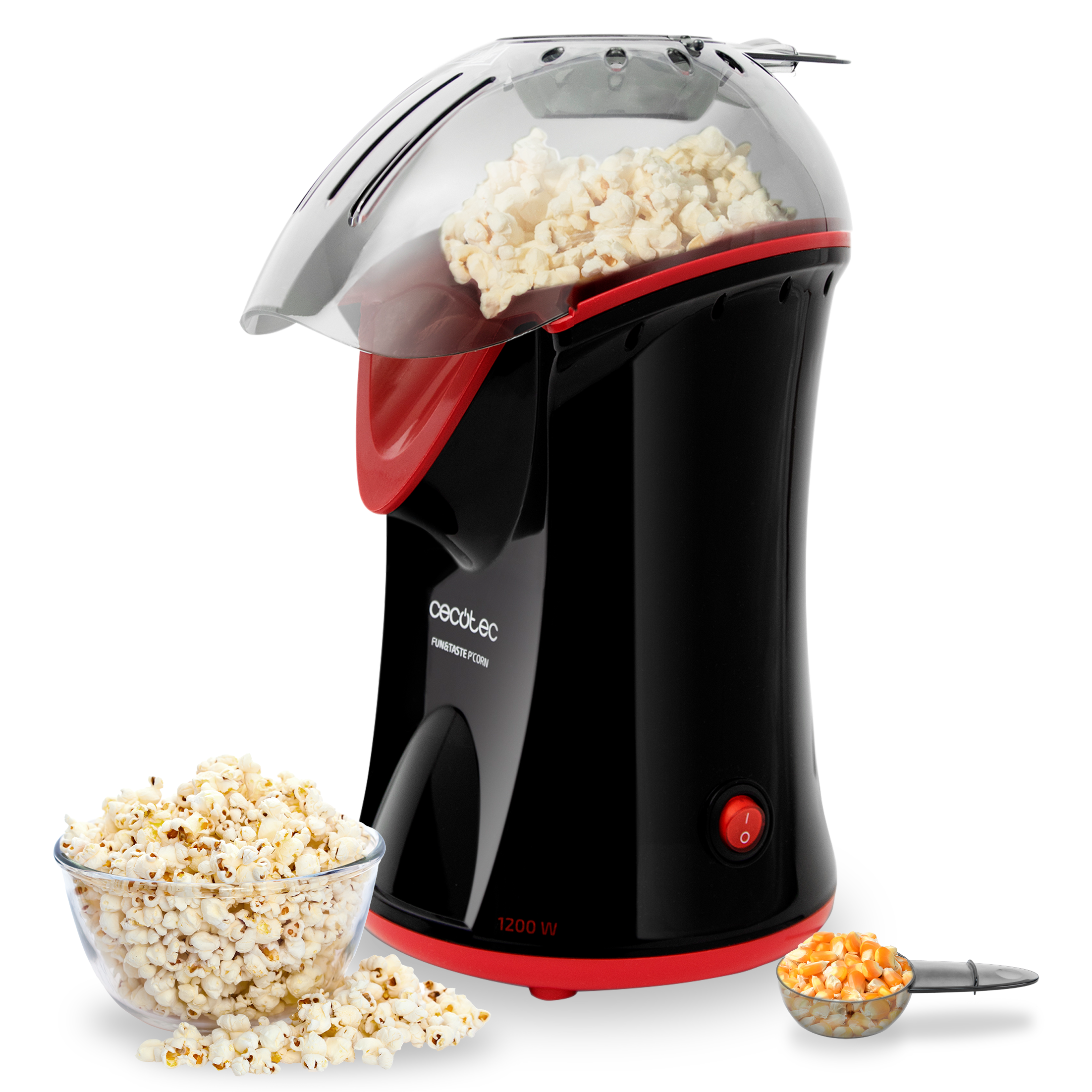 Máquina de palomitas de maíz negra y roja con tapa transparente. Cuenco de palomitas y granos en cuchara y cuenco.