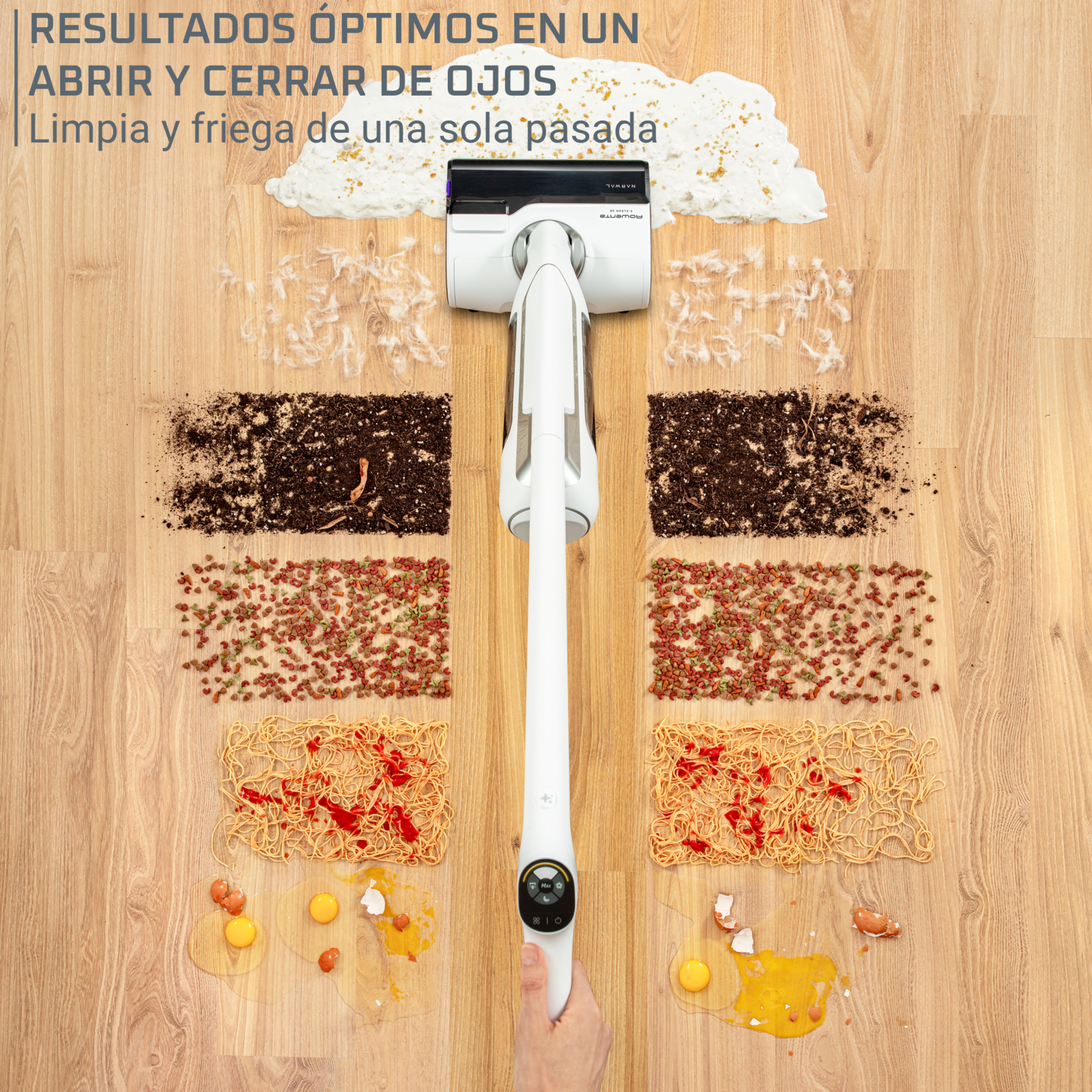 Una aspiradora blanca en un piso de madera, limpiando restos de comida.