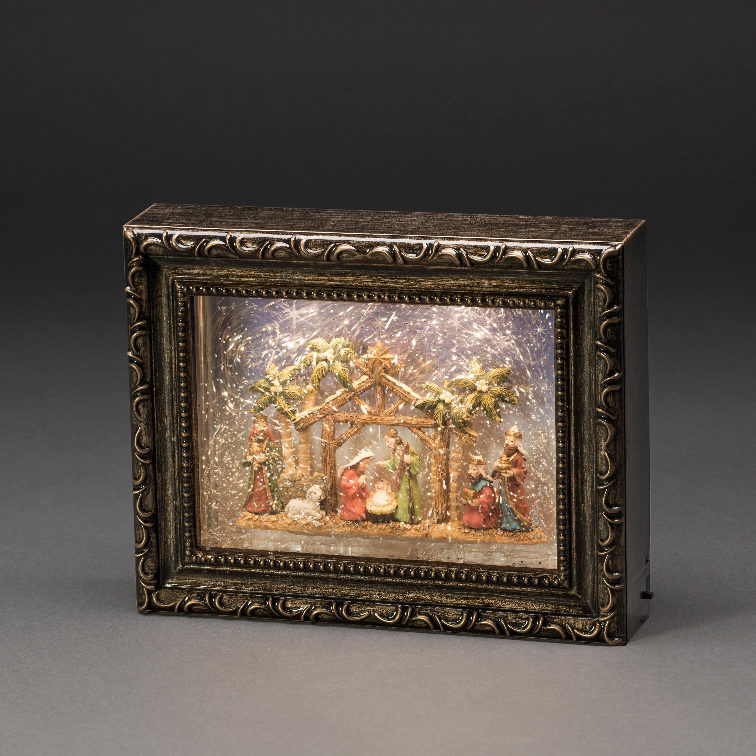 Krippenszene in einer gerahmten Box, mit Figuren und Lichtern.