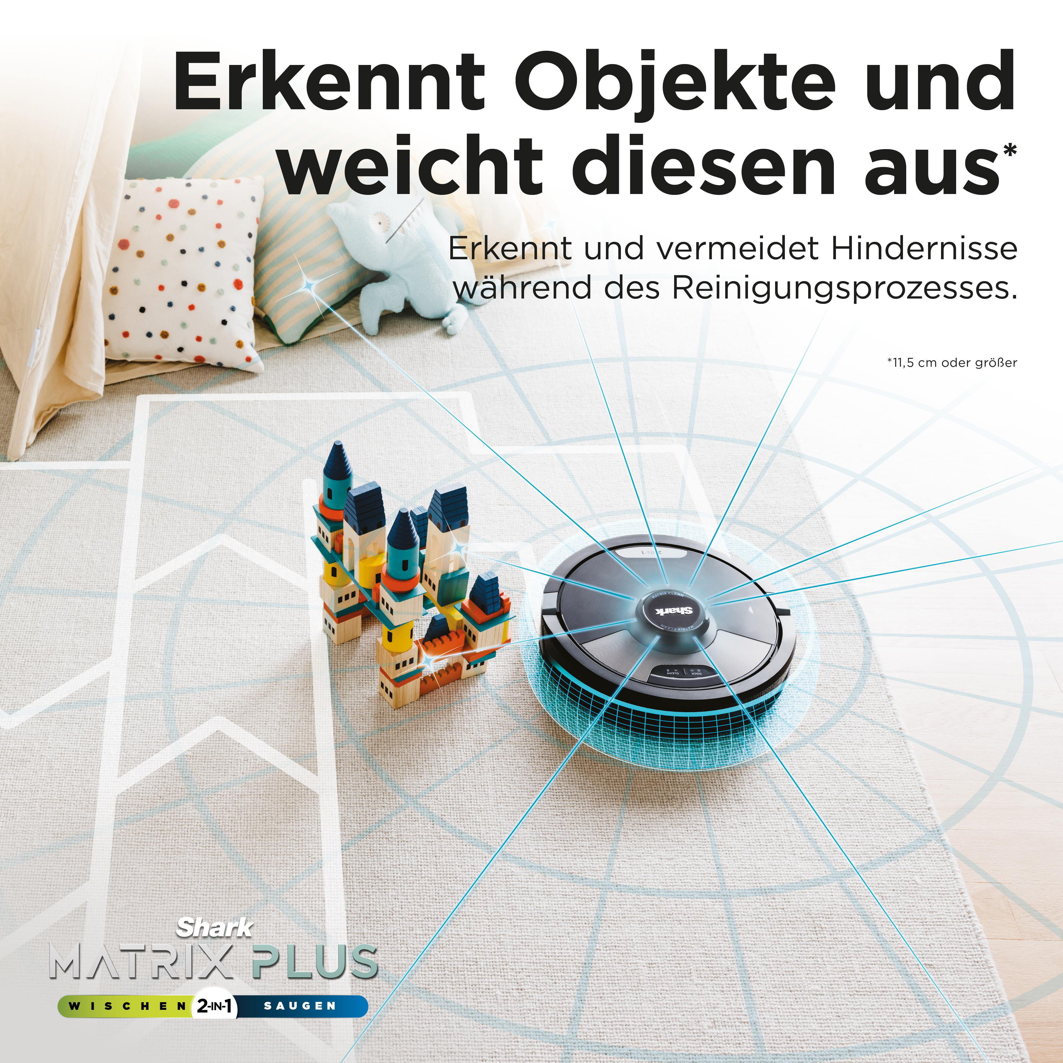 Roboter-Staubsauger auf einem Teppich mit Bausteinen.