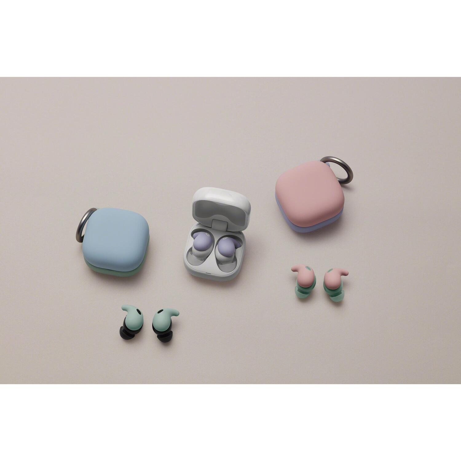 Earbuds and cases. Some cases are open with earbuds inside. Various colors.