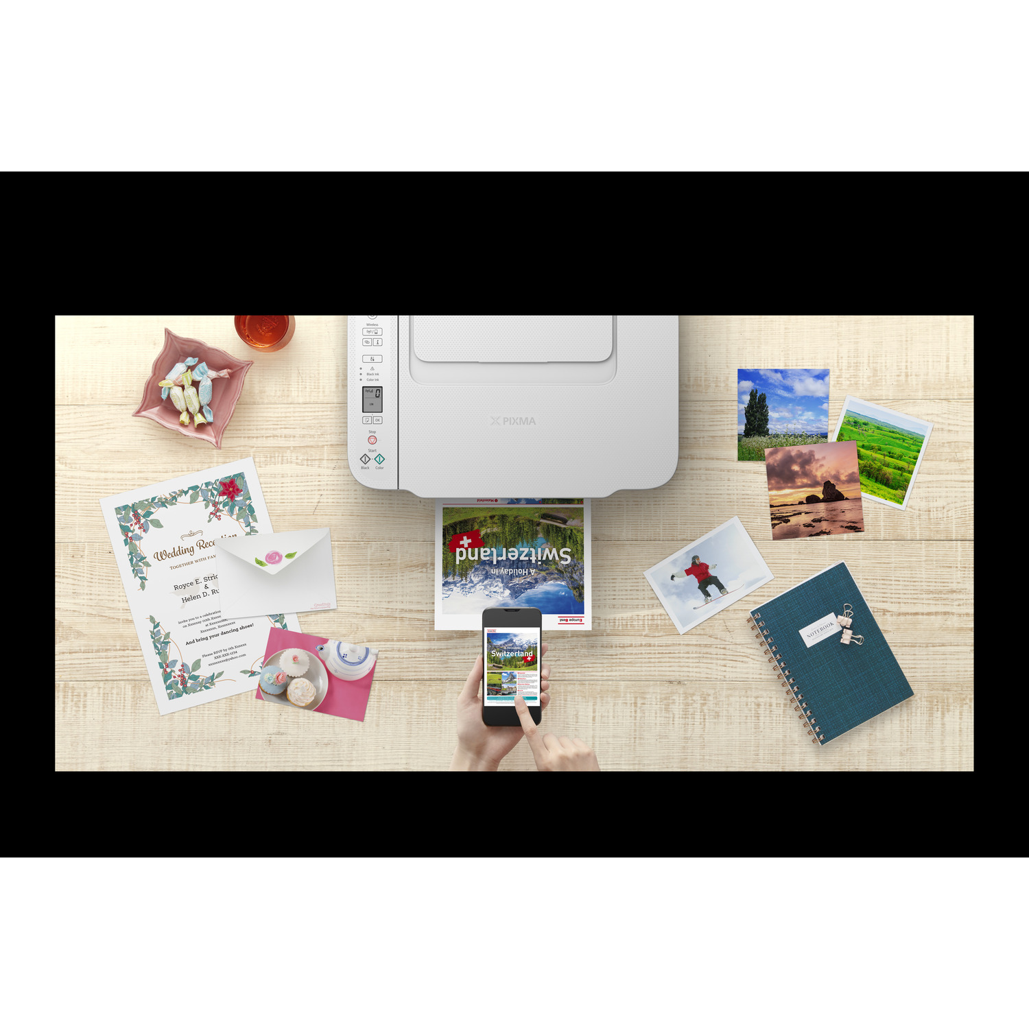 Printer printing pictures and mobile phone with the same picture on screen.