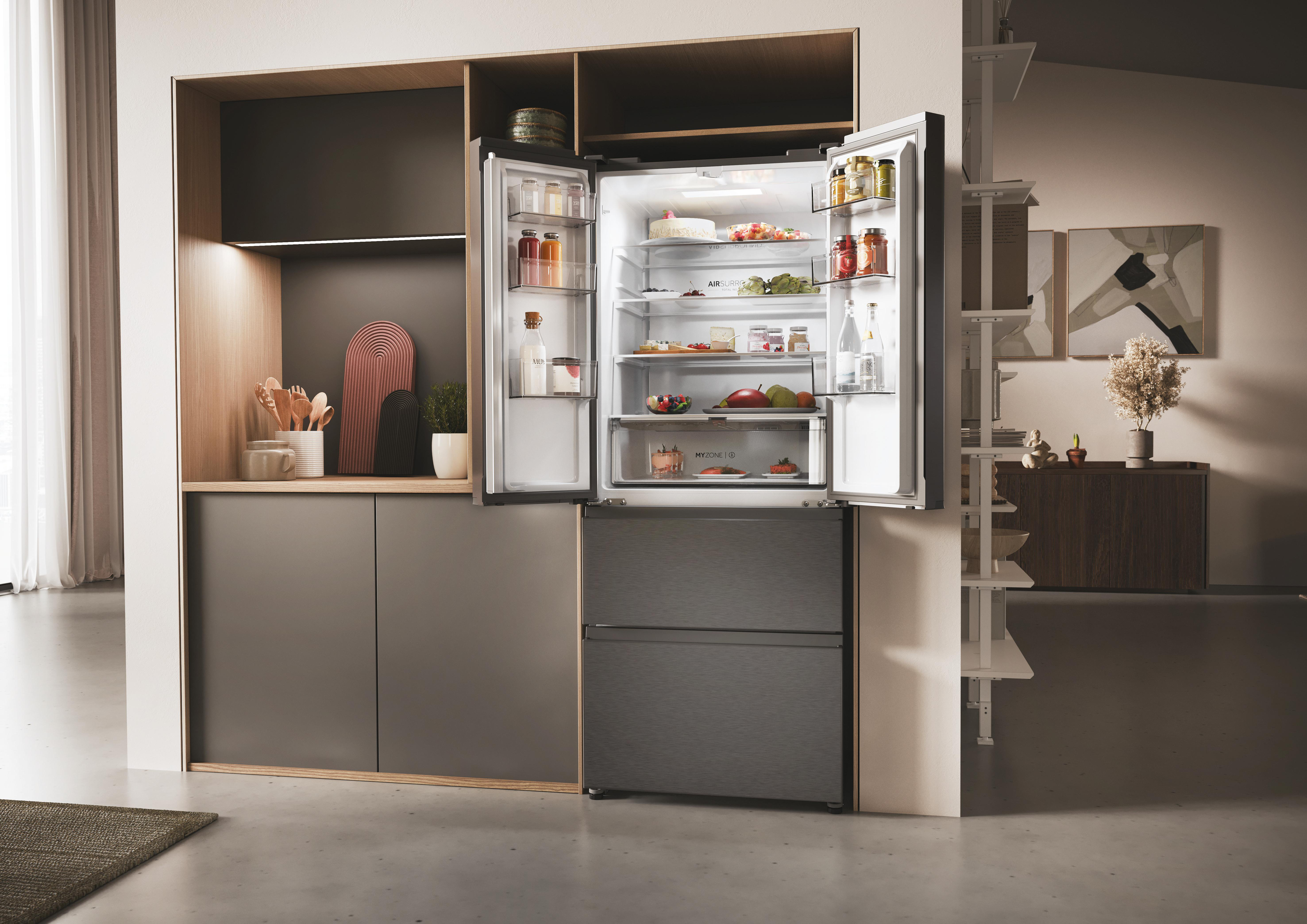 Offener Kühlschrank mit Essen darin, in einer Küche aufgestellt.