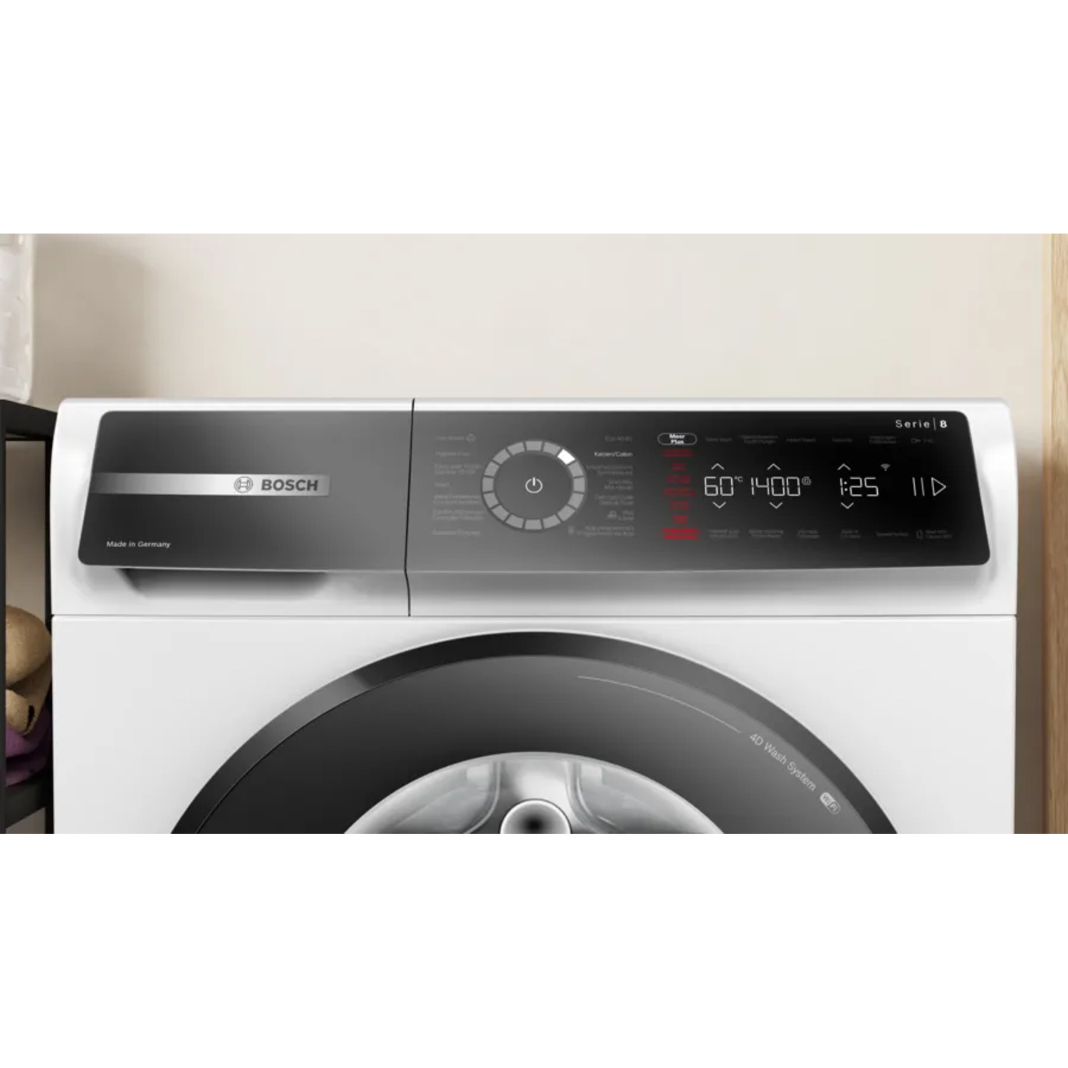 Gros plan sur le panneau de commande d'un lave-linge blanc avec porte noire, montrant les réglages et un affichage numérique.