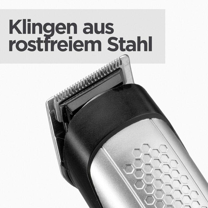 Nahaufnahme eines silbernen und schwarzen Haarschneiders mit Text: Klingen aus rostfreiem Stahl.